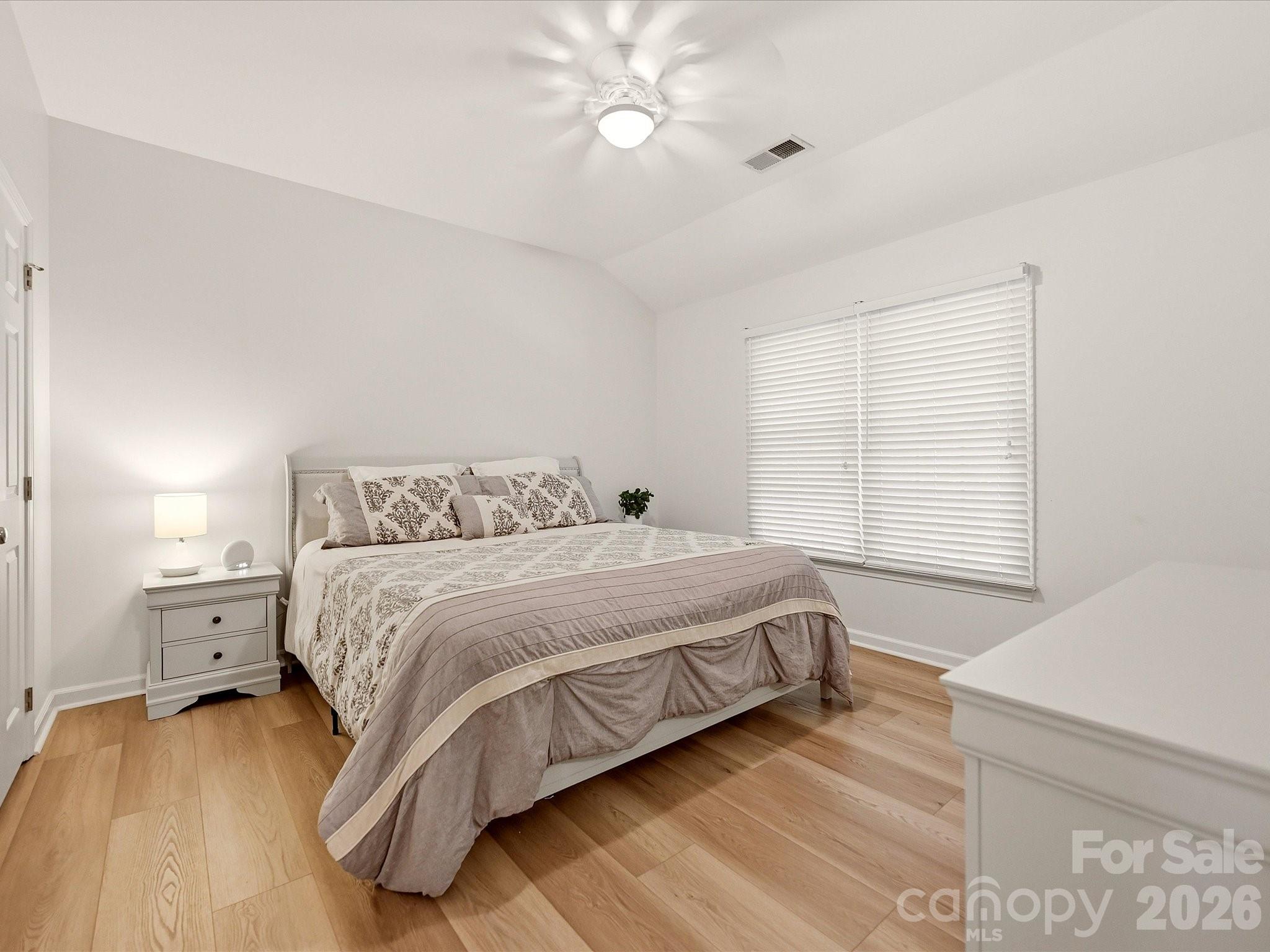 Bright secondary bedroom features wood-look vinyl plank flooring, neutral finishes, and comfortable living space. - 19706 Valiant Way, Cornelius