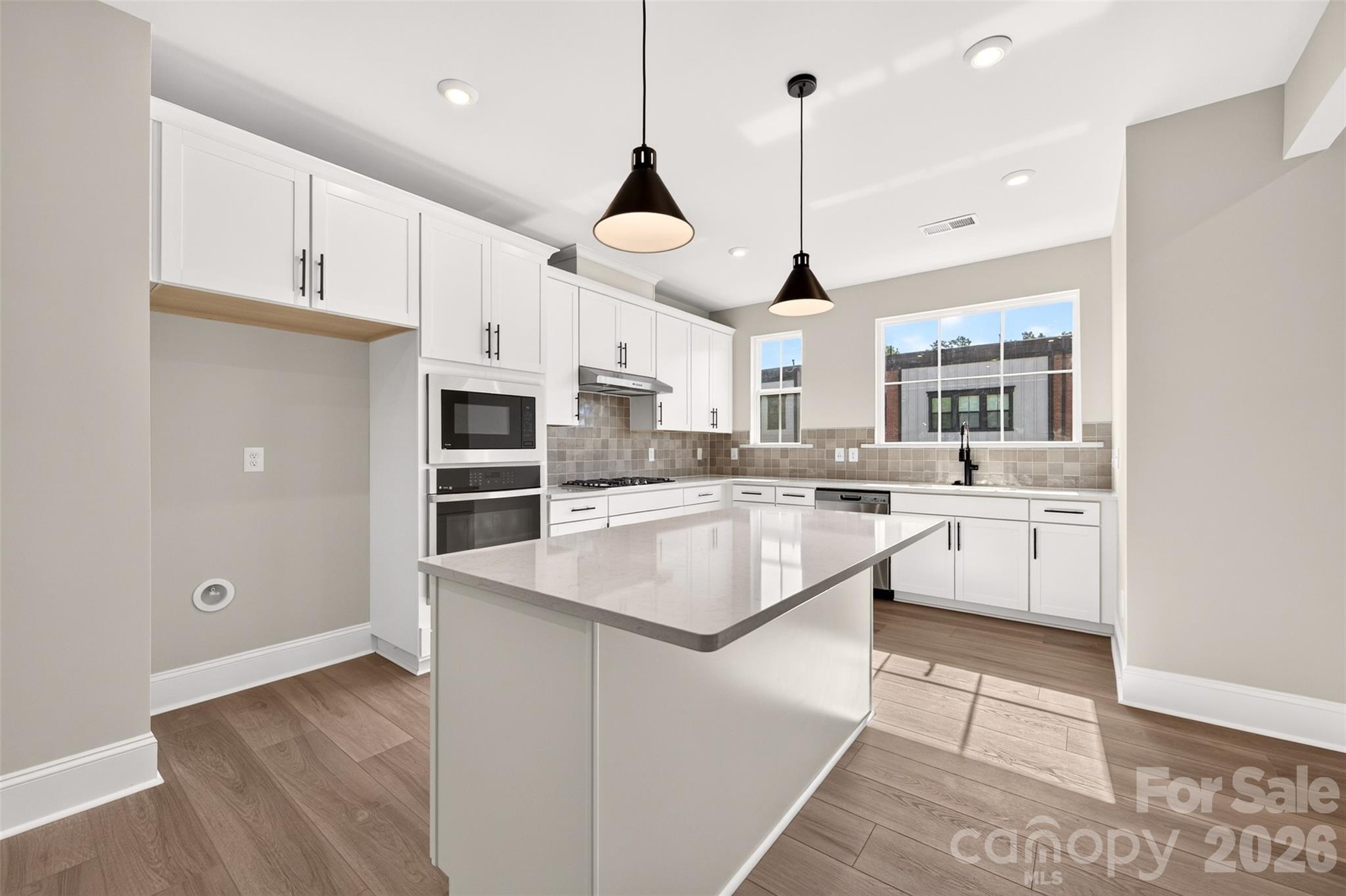 Light filled gourmet kitchen with large windows - 411 Old Town Village Road, Waxhaw