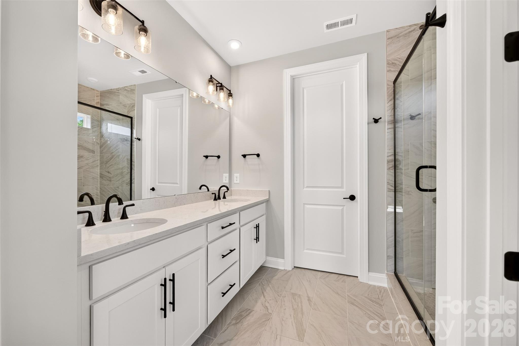 Dual vanity primary bathroom and tiled walk-in shower - 411 Old Town Village Road, Waxhaw