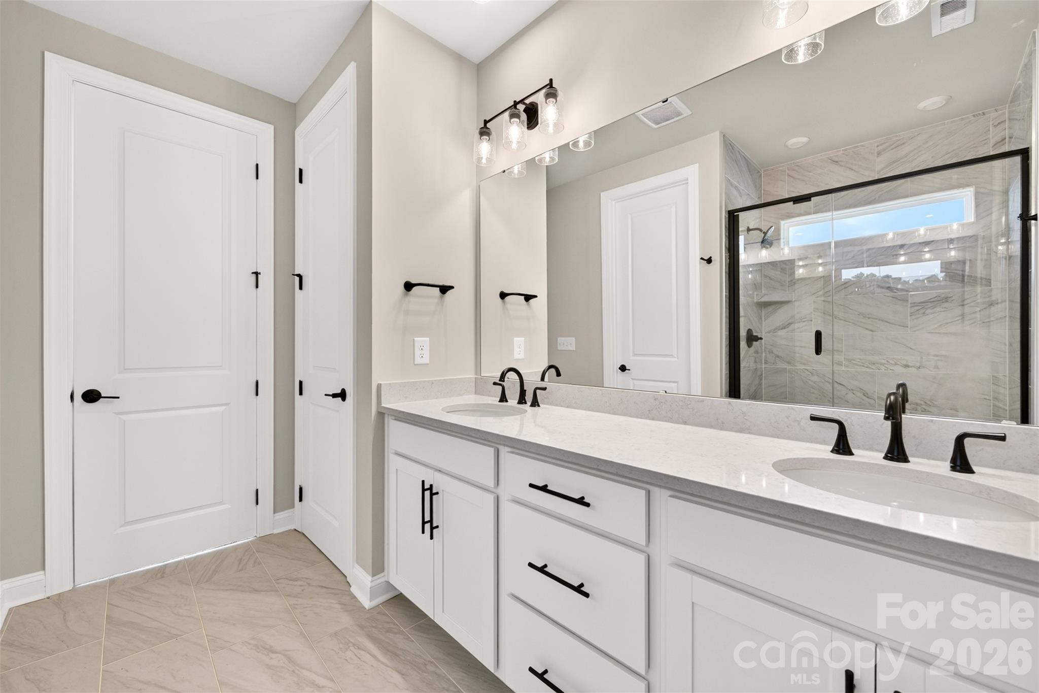 Dual vanity primary bathroom - 411 Old Town Village Road, Waxhaw