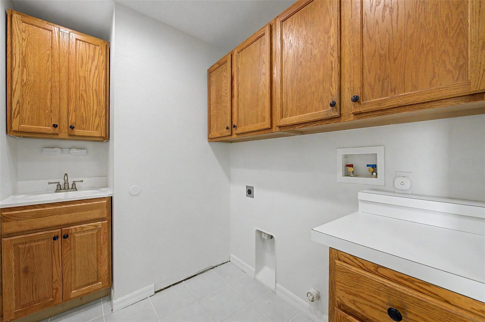 interior laundry room with cabinets - 11709 SPINDRIFT LOOP, HUDSON