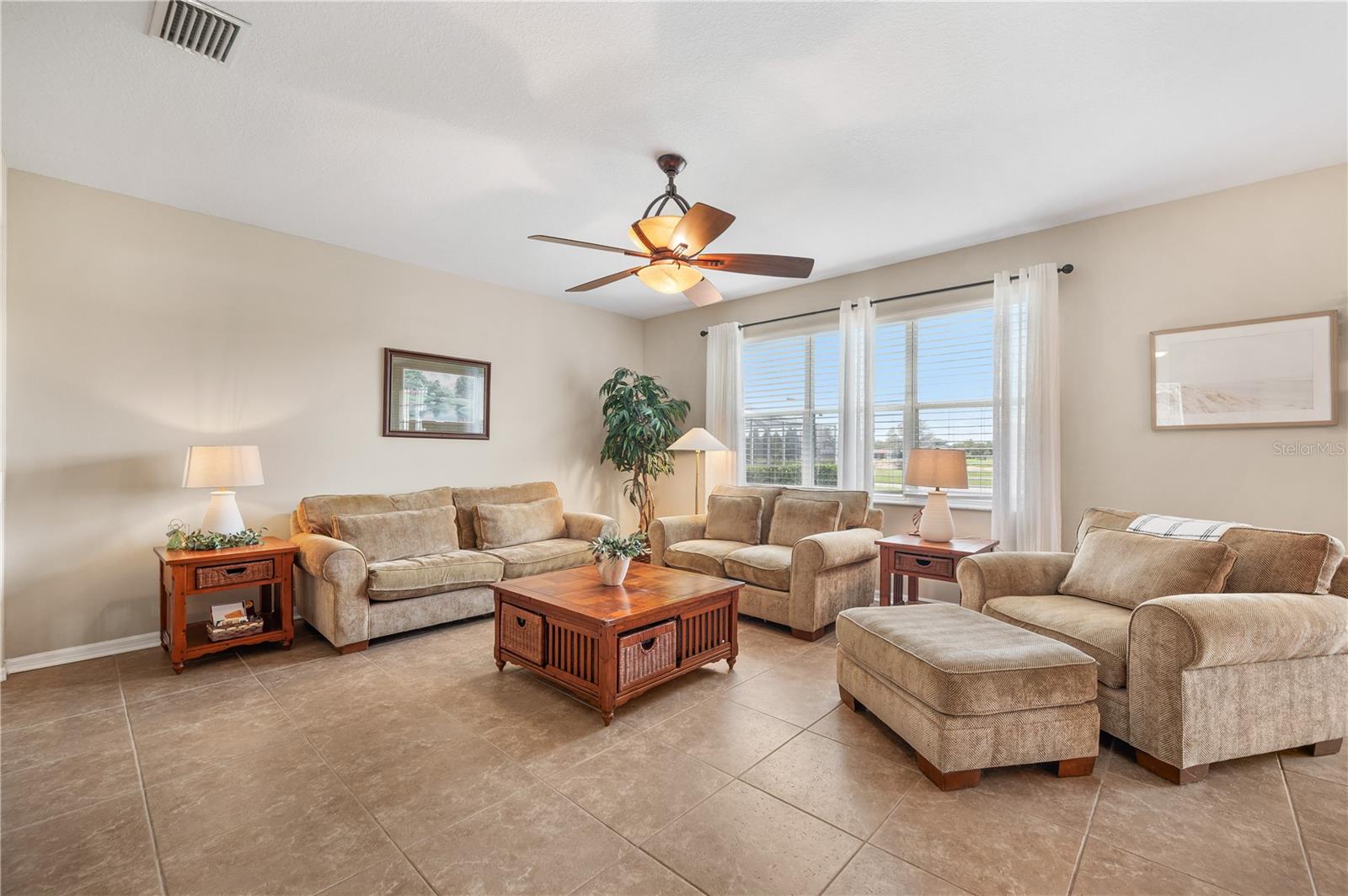 The Family room is over sized, features tall ceilings, tile flooring and a stunning view of the Golf Course & Island Lake - 6937 LAKE EAGLEBROOKE DR, LAKELAND