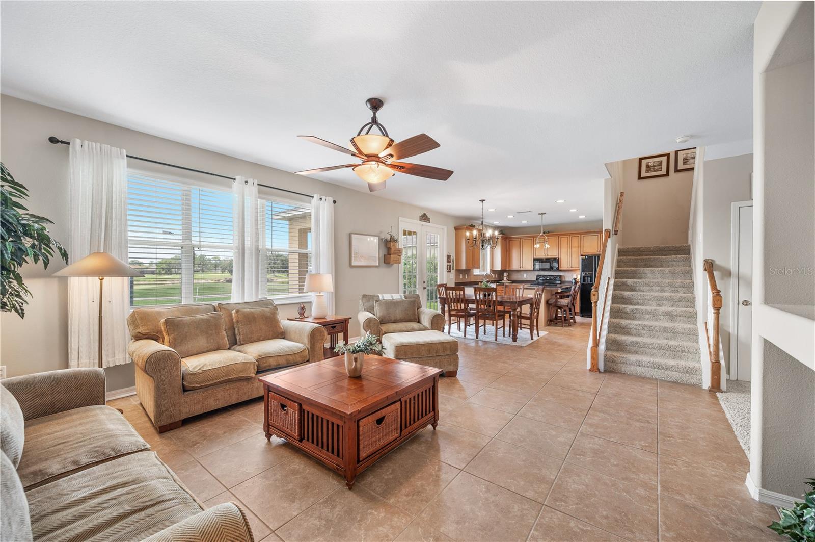 From the family room into the dining space and kitchen beyond! - 6937 LAKE EAGLEBROOKE DR, LAKELAND