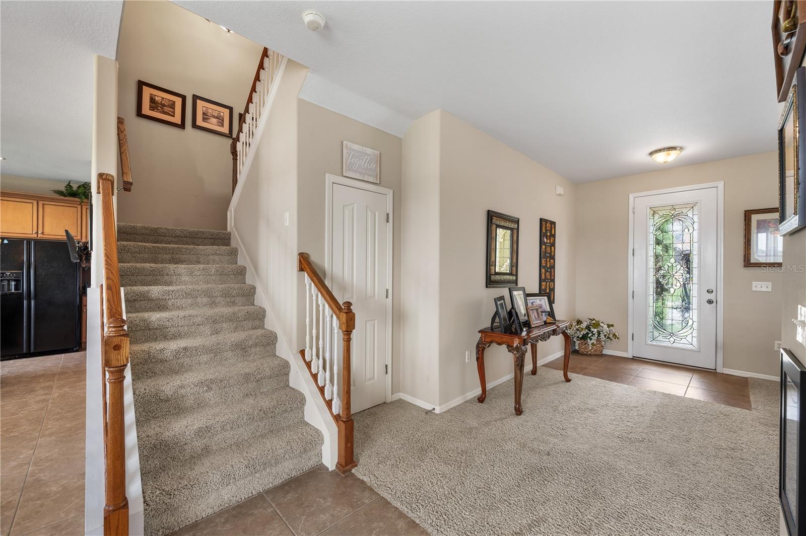 Up to the second floor....the door to the right of the stair case has ample storage. - 6937 LAKE EAGLEBROOKE DR, LAKELAND