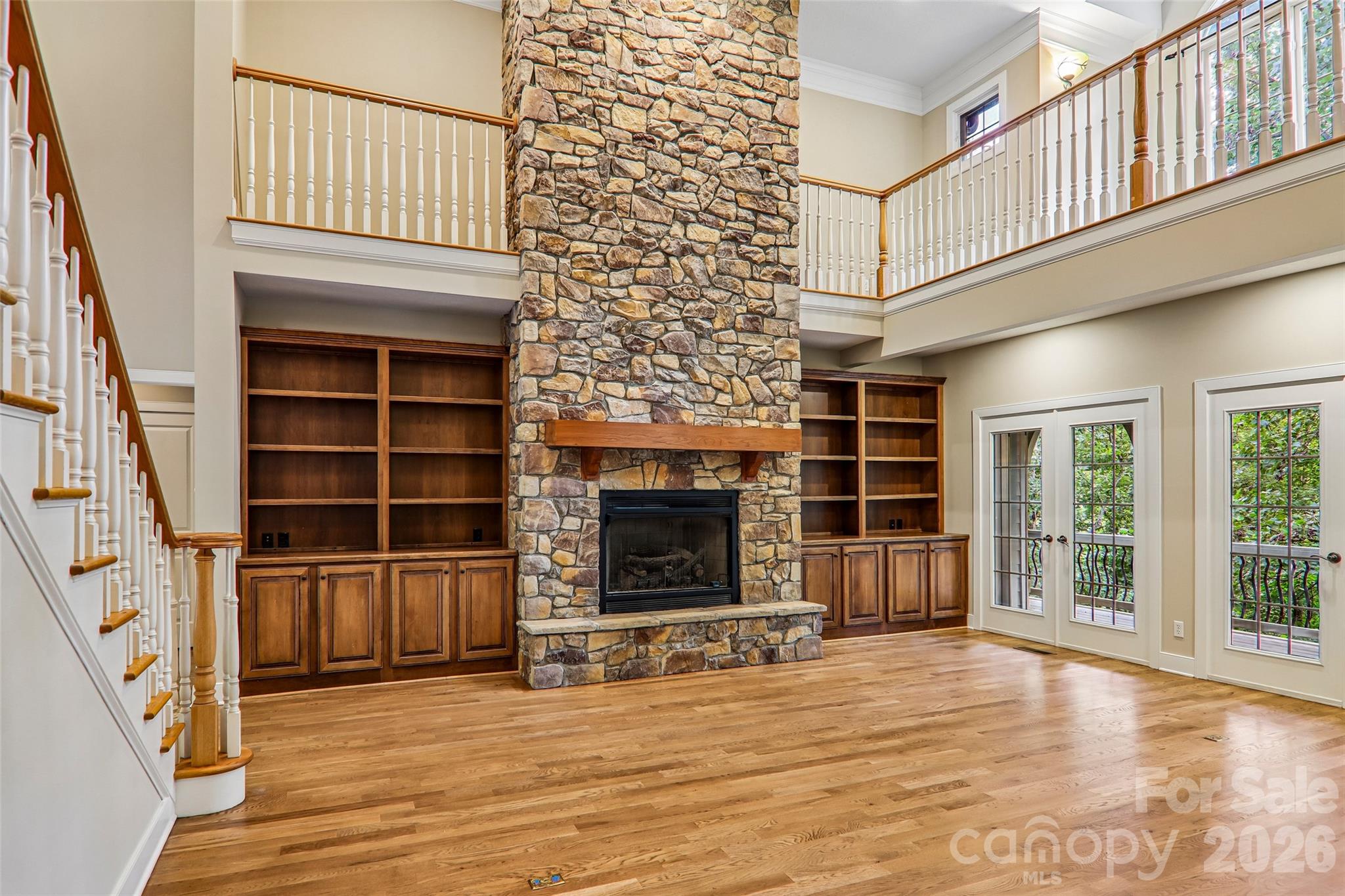 Great room features a vented gas fireplace and built in cabinets/shelves - 361 Mills River Way, Horse Shoe