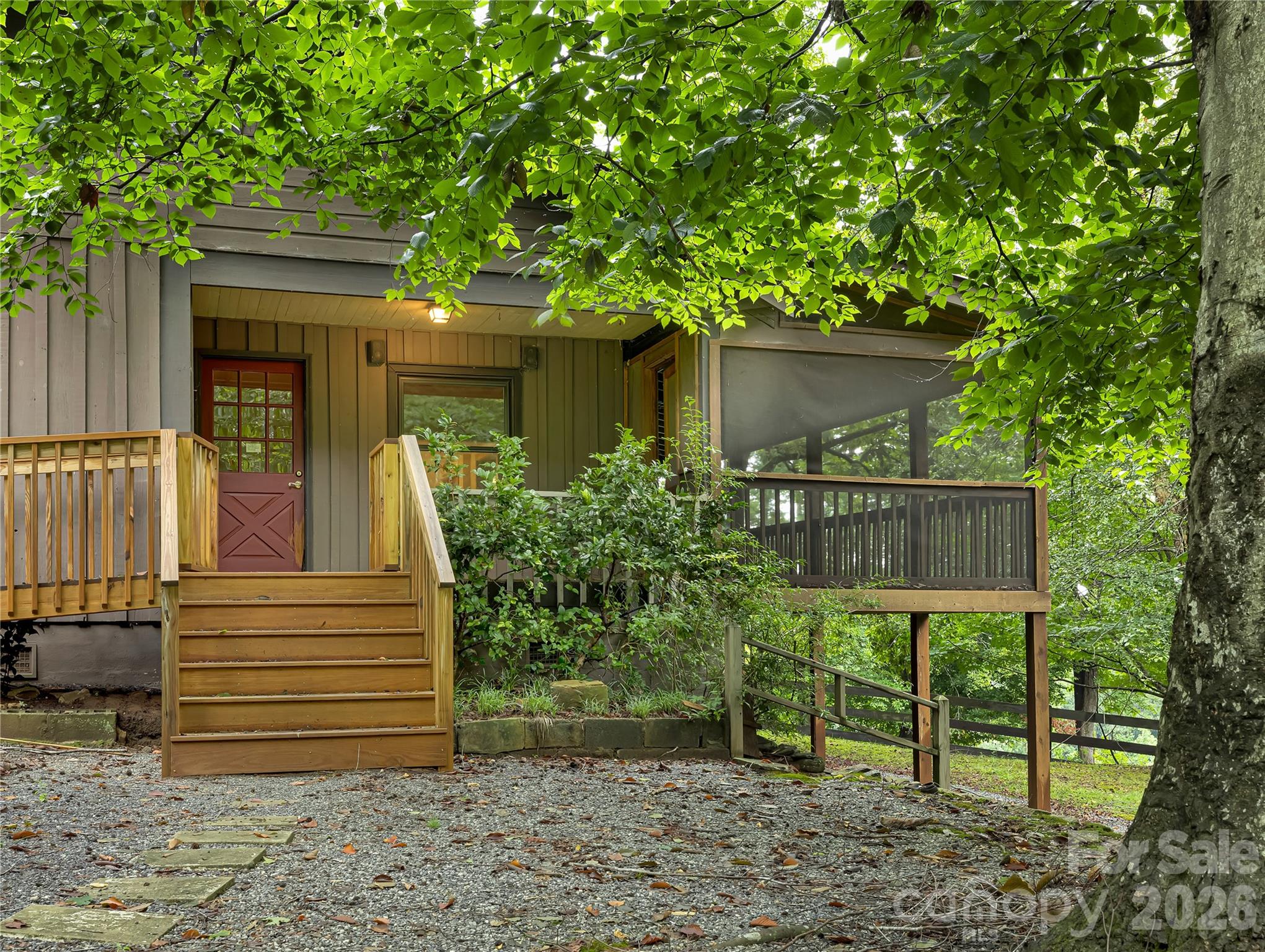 This is a nice cottage with a metal roof, the screened side porch looks over the pasture area. - 989 Fox Mountain Road, Columbus