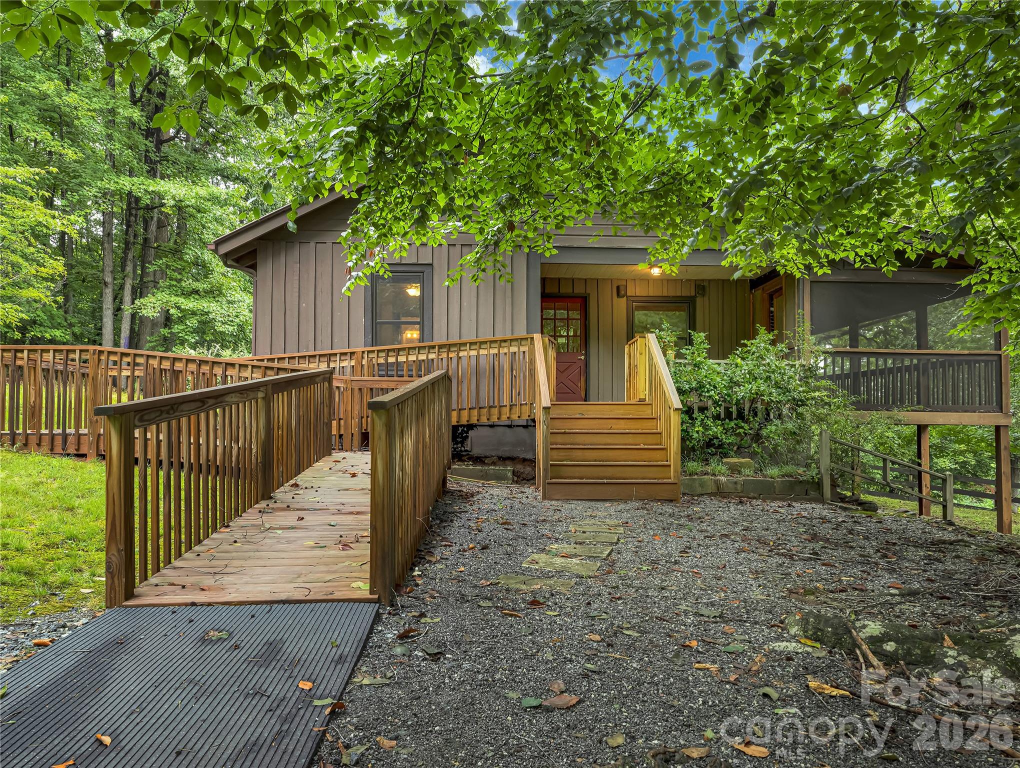 Handicap accessible ramps and a traditional entrance offer two ways to enter the home. There is also a back door with a small porch that opens out to a dog yard with partial fencing that needs some repair. - 989 Fox Mountain Road, Columbus
