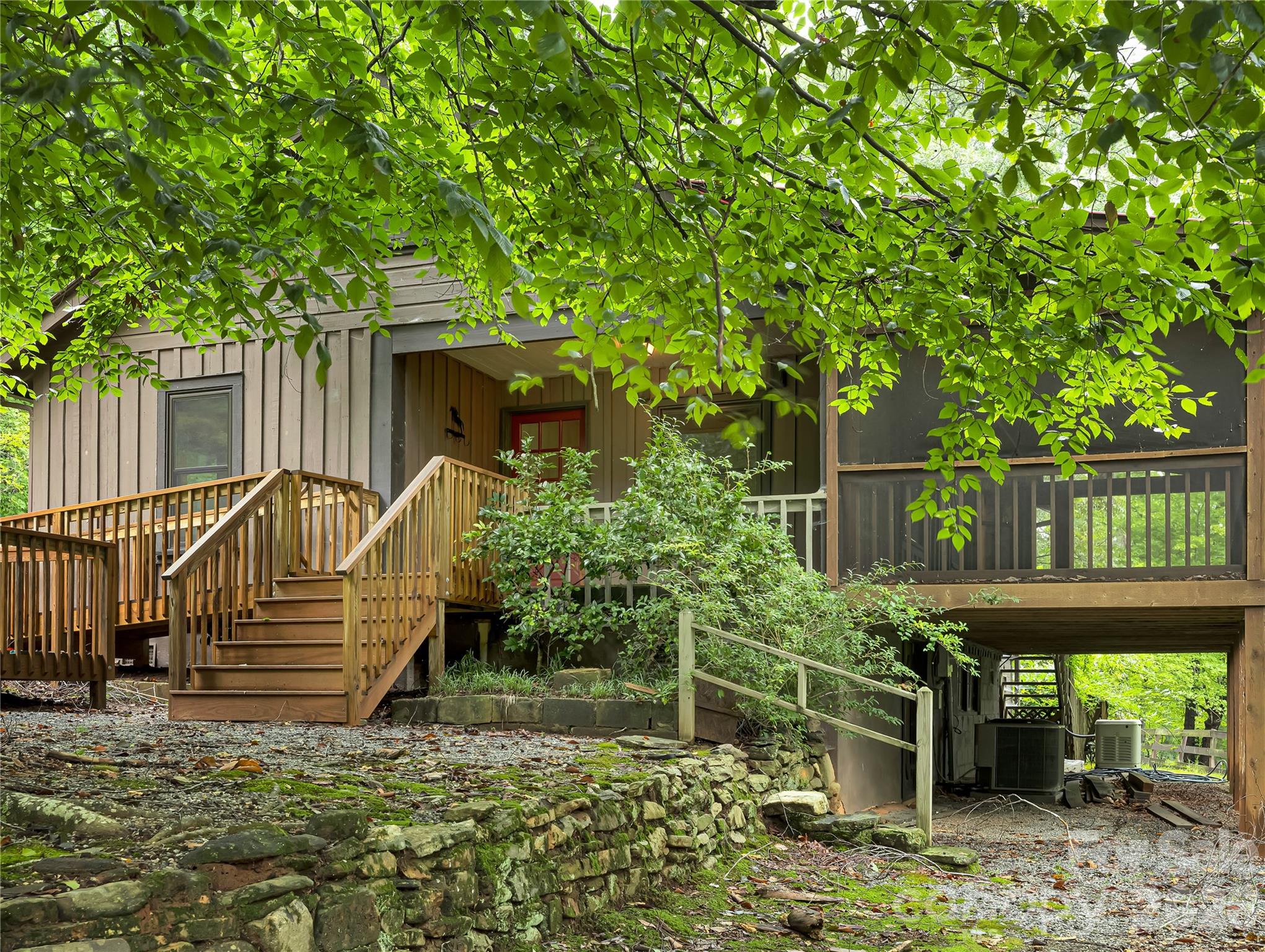 Stone steps and a stone wall lead to storage under the porch and access to the crawl space/utilities area. - 989 Fox Mountain Road, Columbus