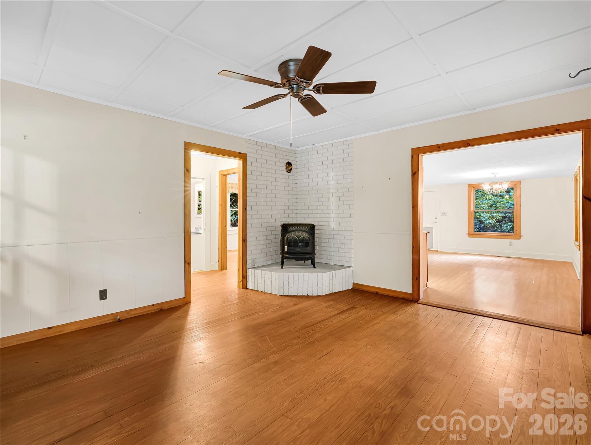 Living room has a stove ready to hook up for extra heat this winter. Large opening to the right is the kitchen dining area. - 989 Fox Mountain Road, Columbus