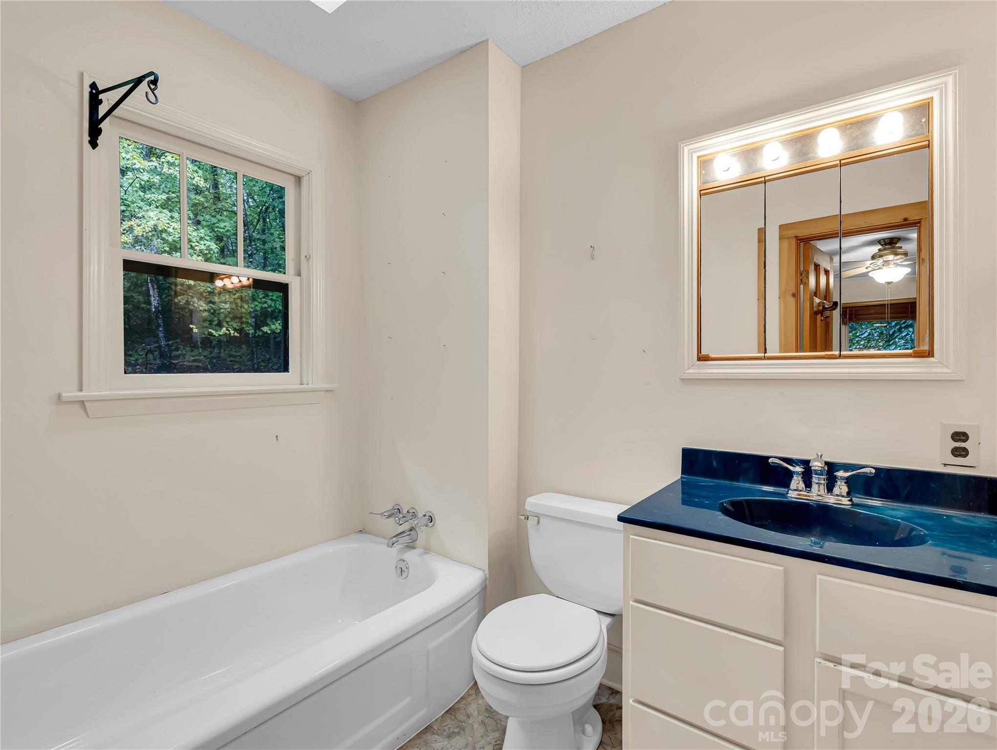 Full bath with skylight, accessed from front bedroom and the center hall off of living room. - 989 Fox Mountain Road, Columbus