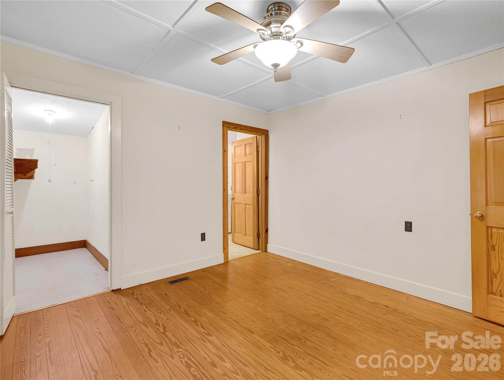 Back bedroom with walk in closet, wood floors. - 989 Fox Mountain Road, Columbus