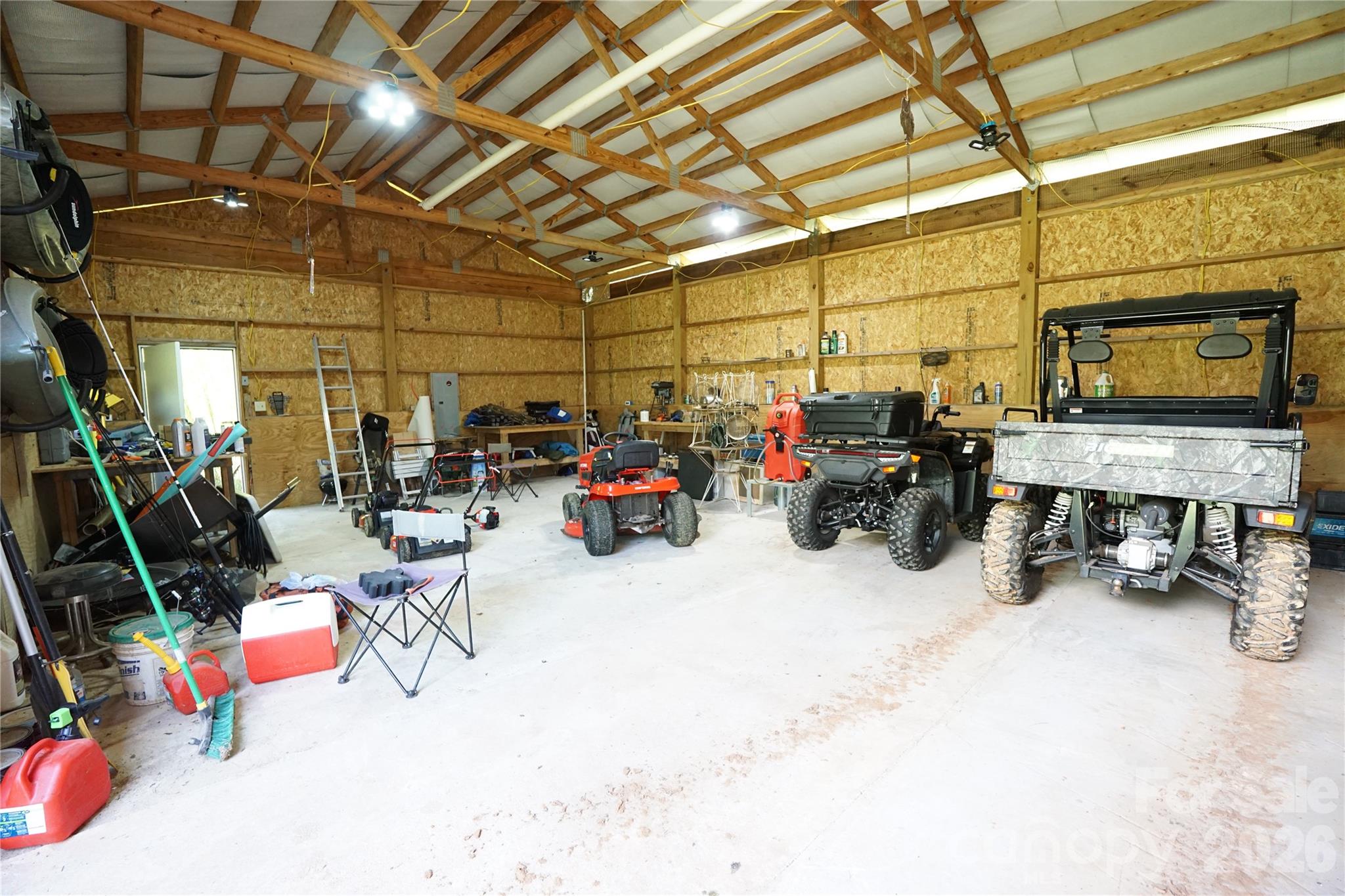 744 Square Foot workshop with cement floor, electric, and water outside door. - 1239 W McGuinn Road, Mill Spring