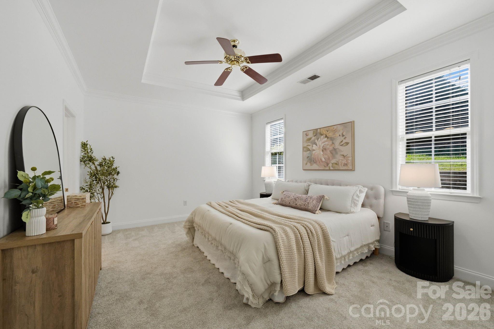 Main-level primary suite with generous space, natural light, and a large walk-in closet. - 18810 Cloverstone Circle, Cornelius