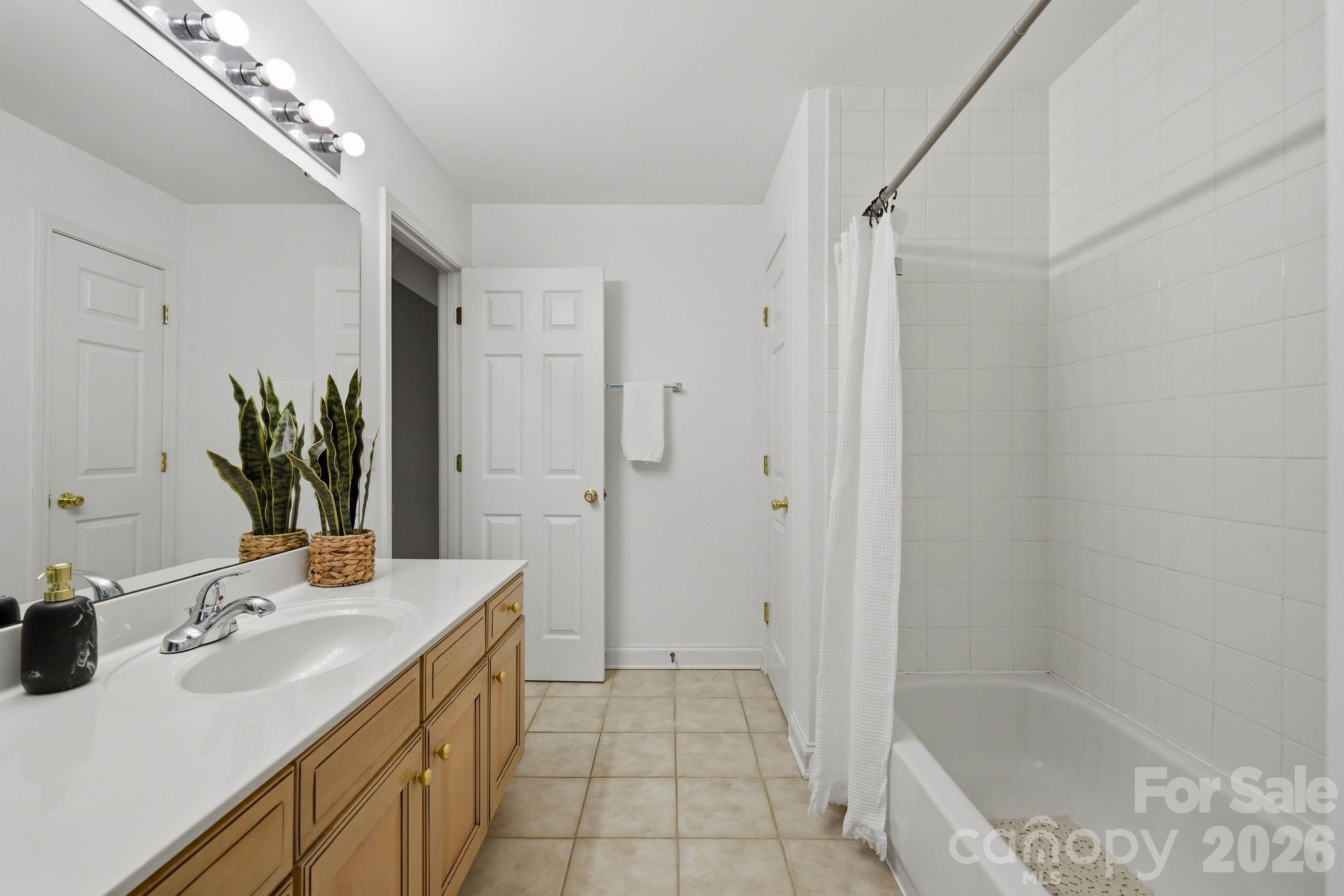 Bright upstairs bathroom offers a functional layout for guests and secondary bedrooms. - 18810 Cloverstone Circle, Cornelius