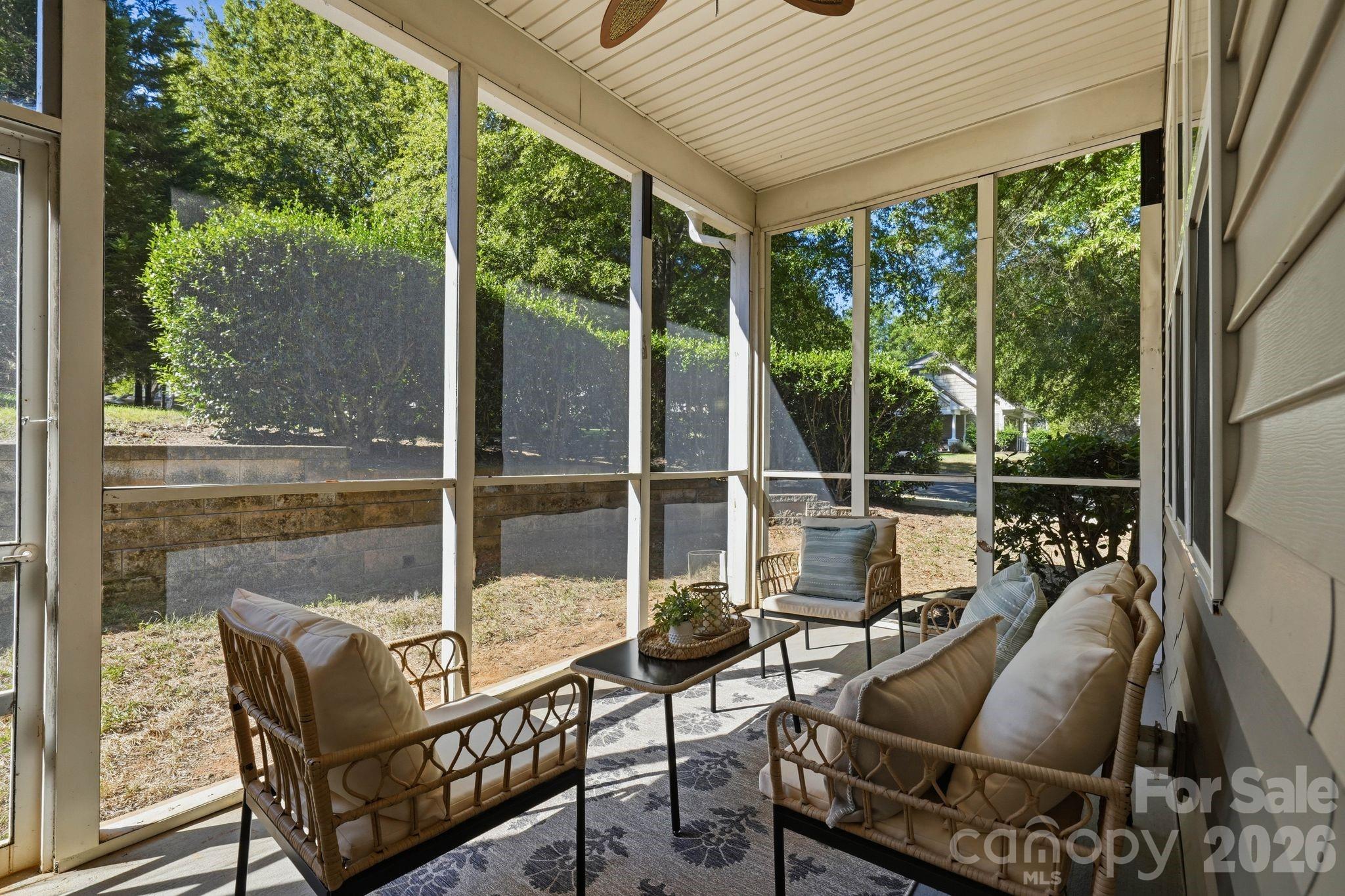 Covered screened porch offers a comfortable place to enjoy the outdoors throughout much of the year. - 18810 Cloverstone Circle, Cornelius