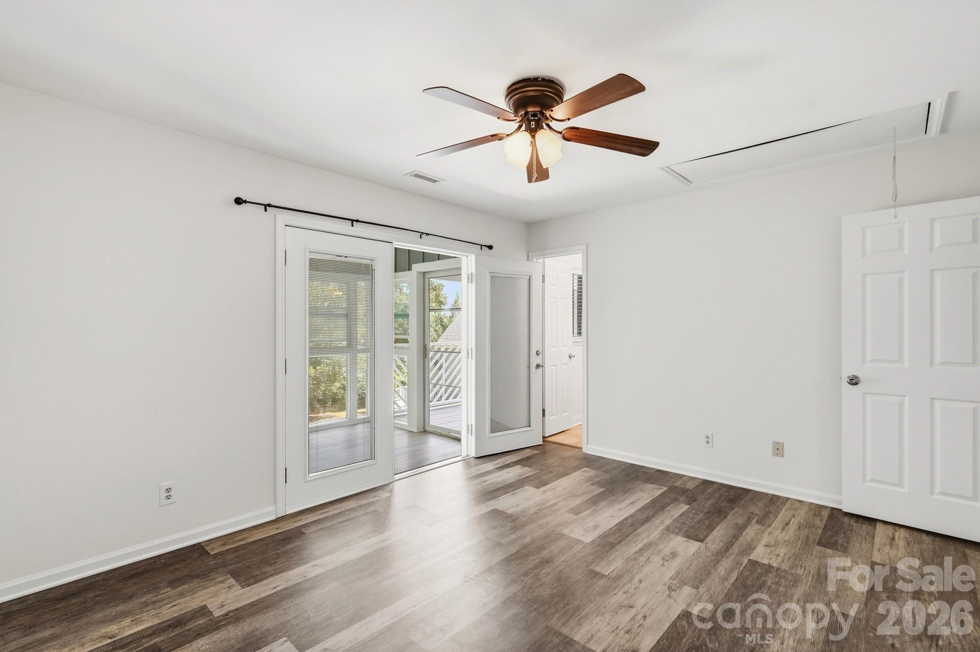 The private, spacious primary suite overlooks the beautiful backyard pool and offers direct access to the four-season sunroom and deck, creating a seamless connection between indoor and outdoor living. - 3022 Point Clear Drive, Tega Cay