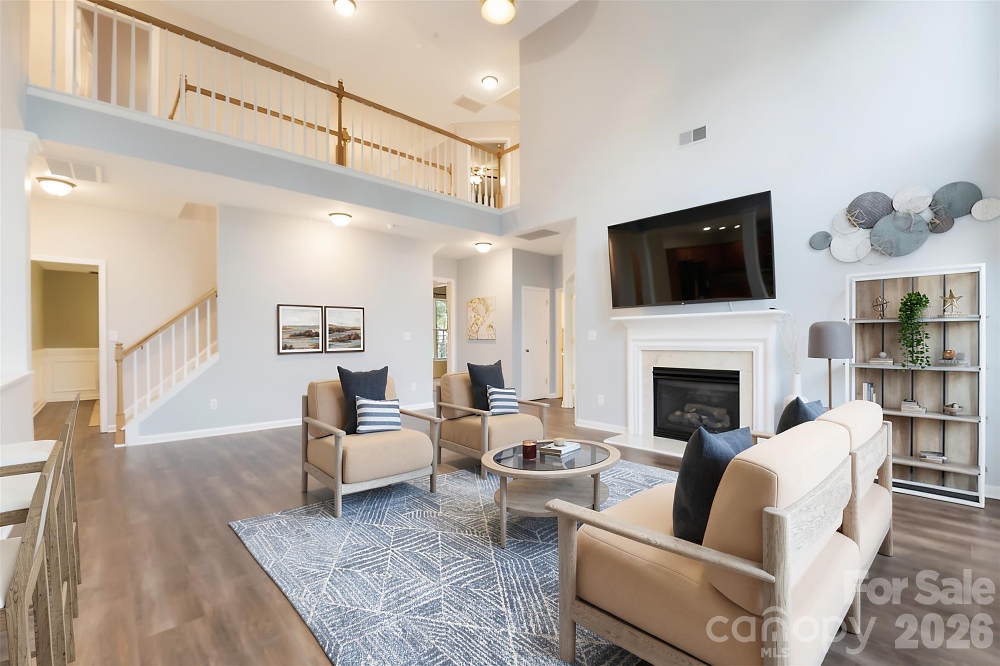 Spacious two-story family room featuring soaring ceilings, abundant natural light, and a welcoming layout. - 144 Steeplechase Avenue, Mooresville