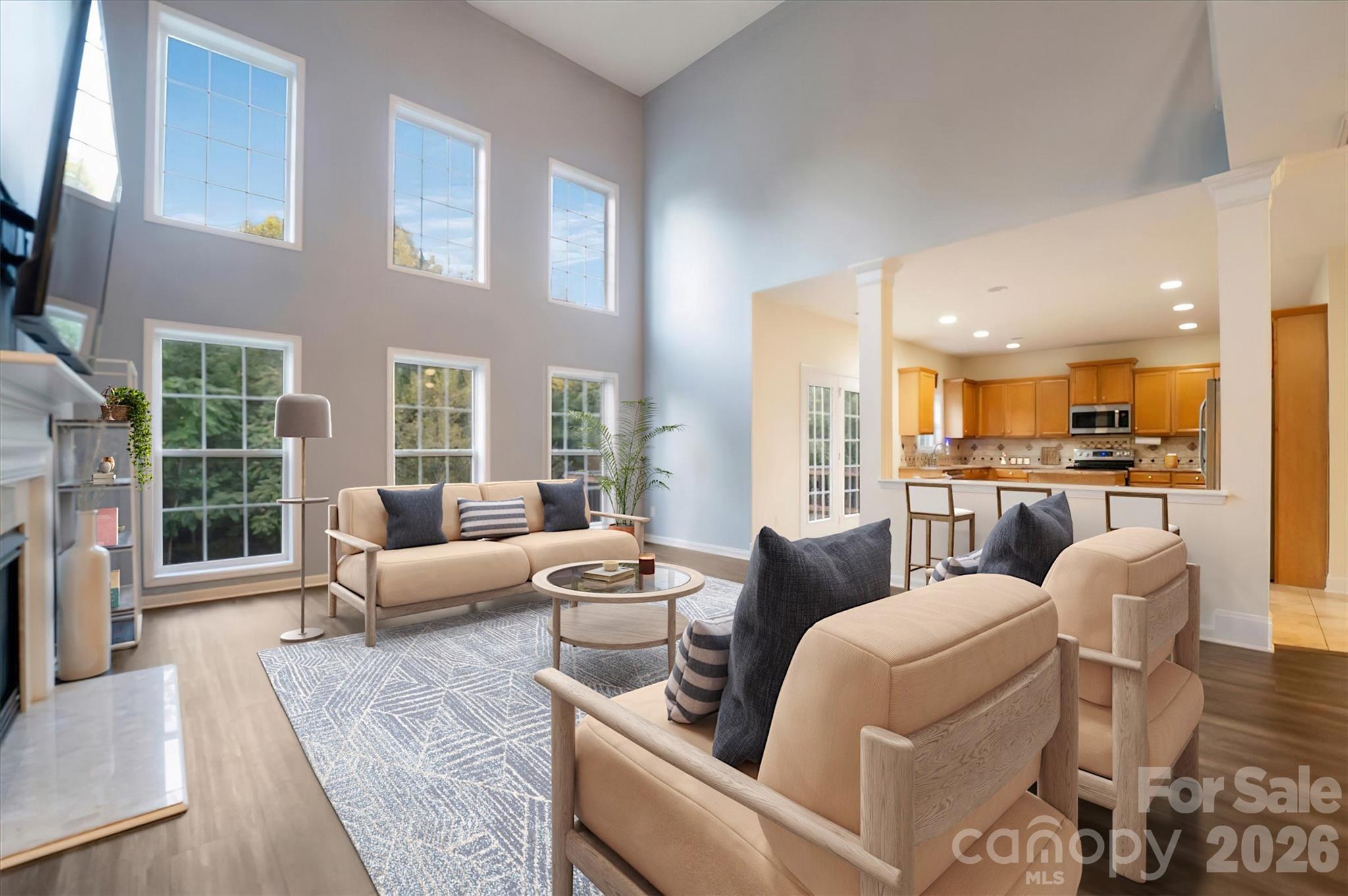 Two-story family room showcases windows overlooking the backyard, and a beautiful fireplace serving as the focal point of this bright and inviting living space. - 144 Steeplechase Avenue, Mooresville