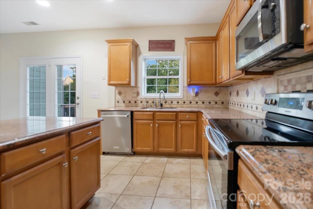 Kitchen with island and granite countertops. - 144 Steeplechase Avenue, Mooresville