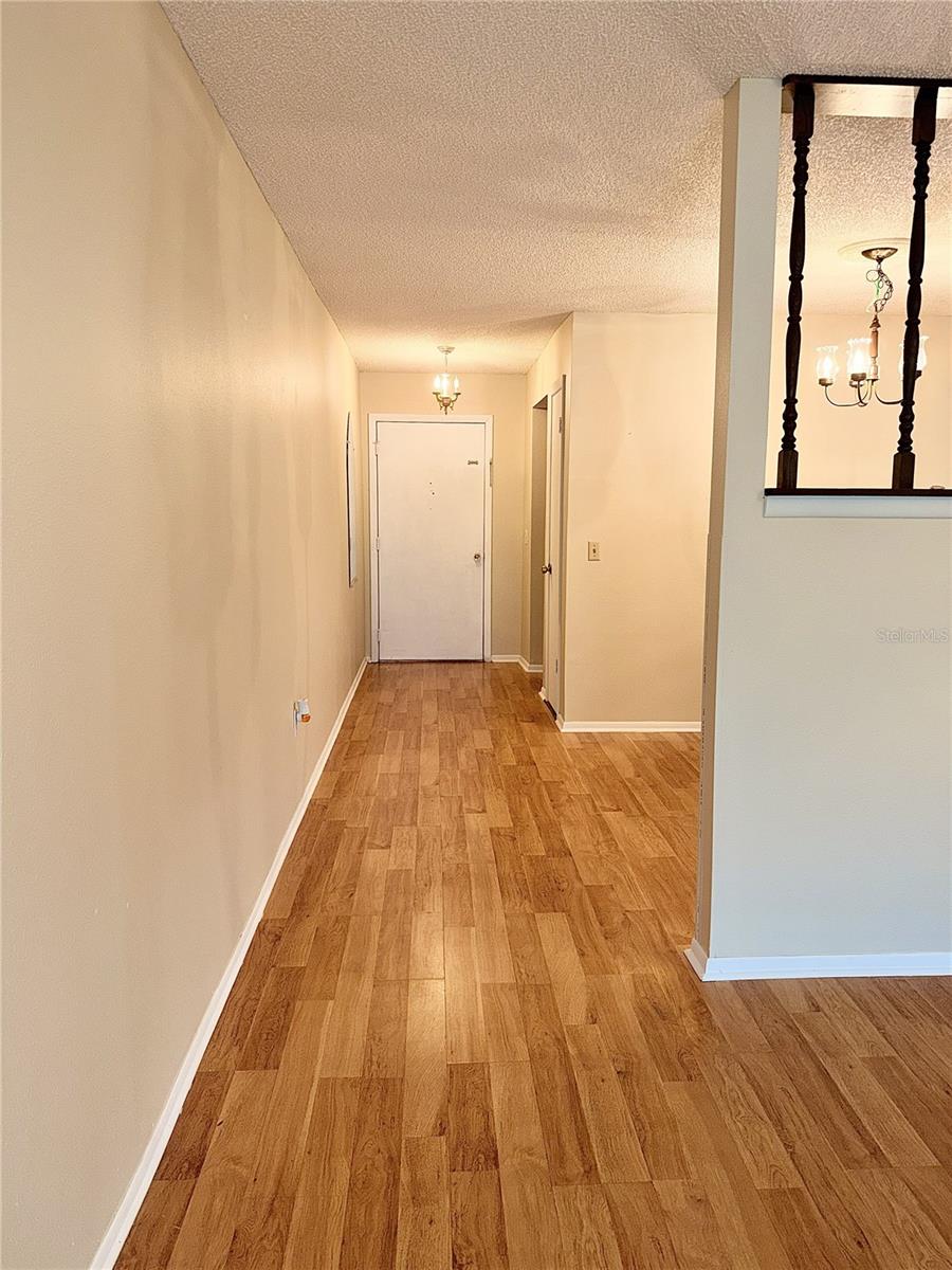 View from living room to dingroom and front door - 4140 PASSPORT LN #101, NEW PORT RICHEY