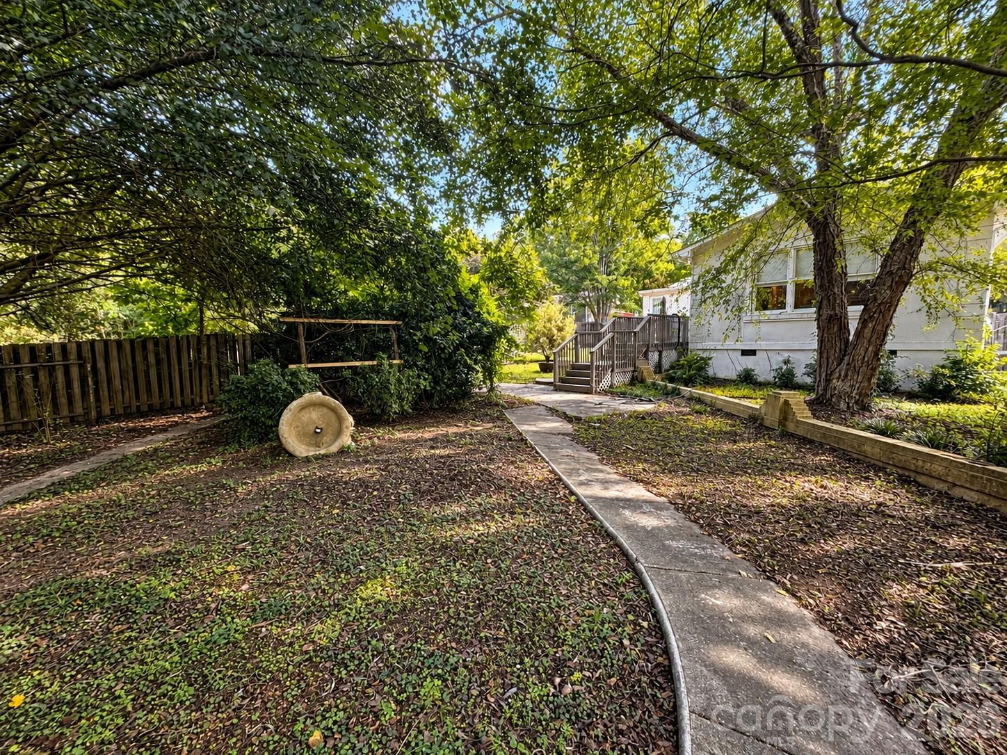 Shaded Backyard Path to Deck - 4711 Summit Avenue, Greensboro
