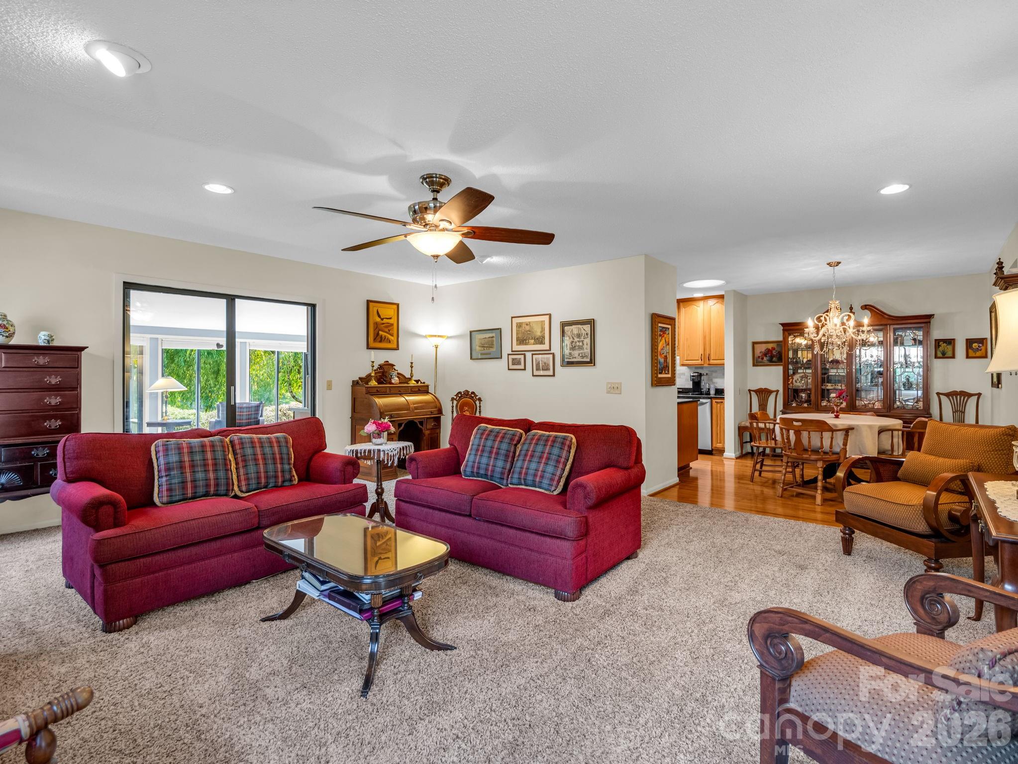Living room with propane gas fireplace, sliding doors to 4 seasons sunroom, abundant natural light, new fireplace surround - 31 Willow Way, Hendersonville