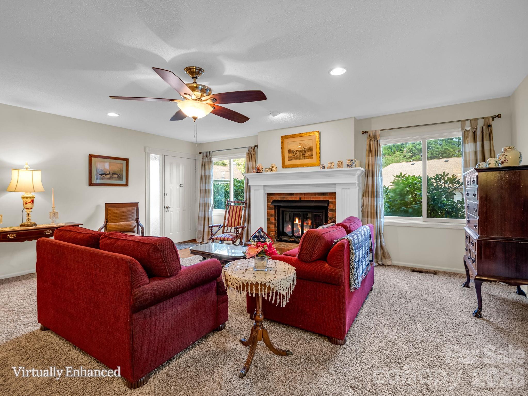 Living room with propane gas fireplace, sliding doors to 4 seasons sunroom, abundant natural light, new fireplace surround - 31 Willow Way, Hendersonville