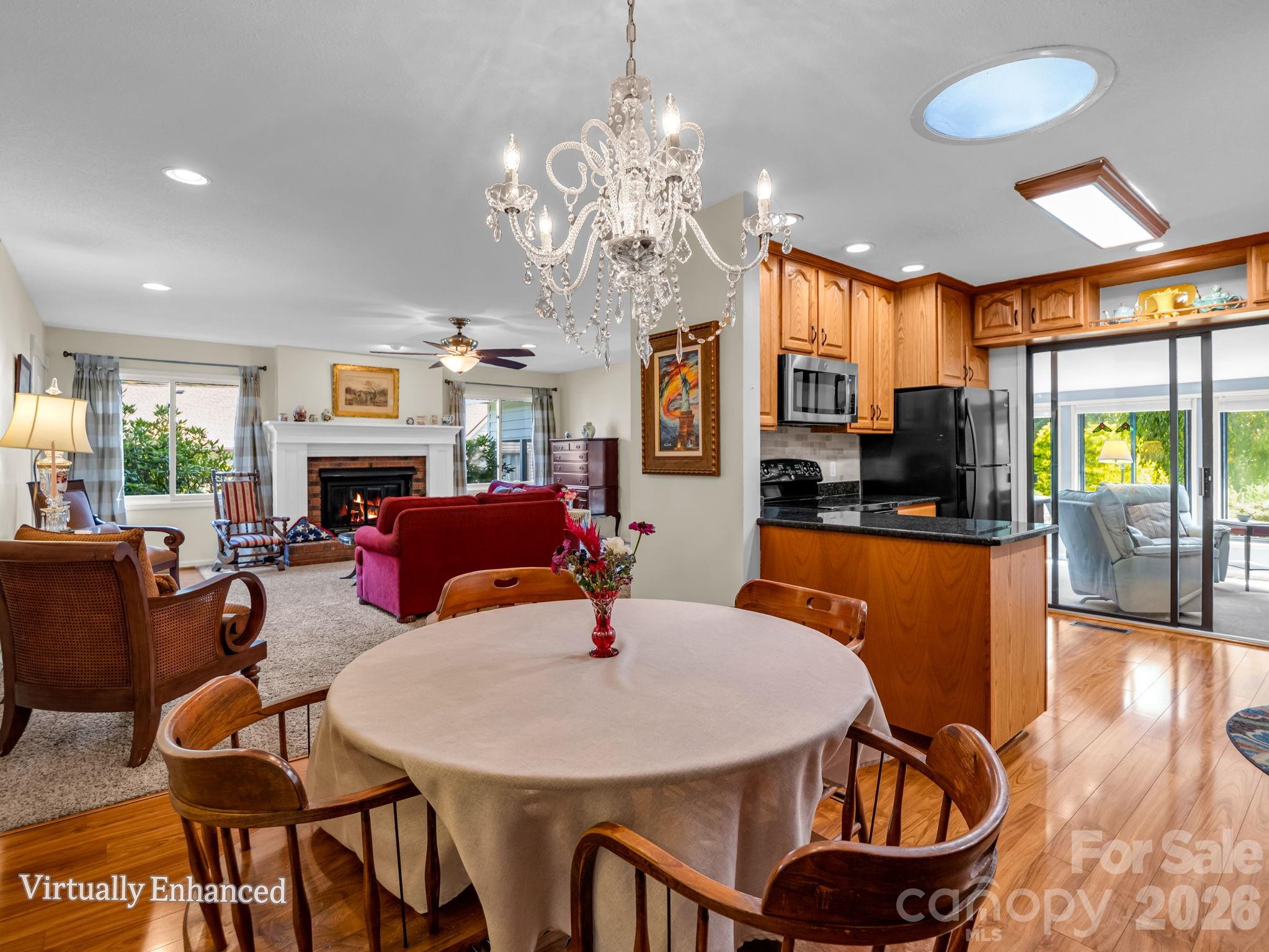 View from dining room into living area to left and kitchen to the right - 31 Willow Way, Hendersonville