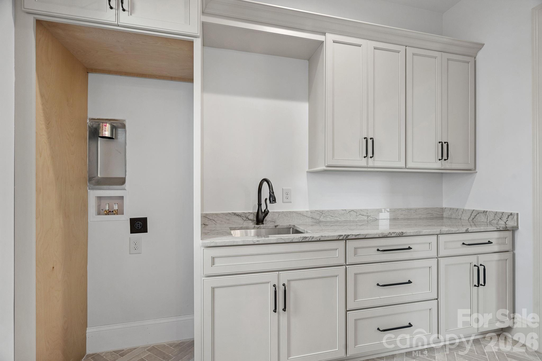 main floor laundry room - 7679 Rabbit Circle, Denver