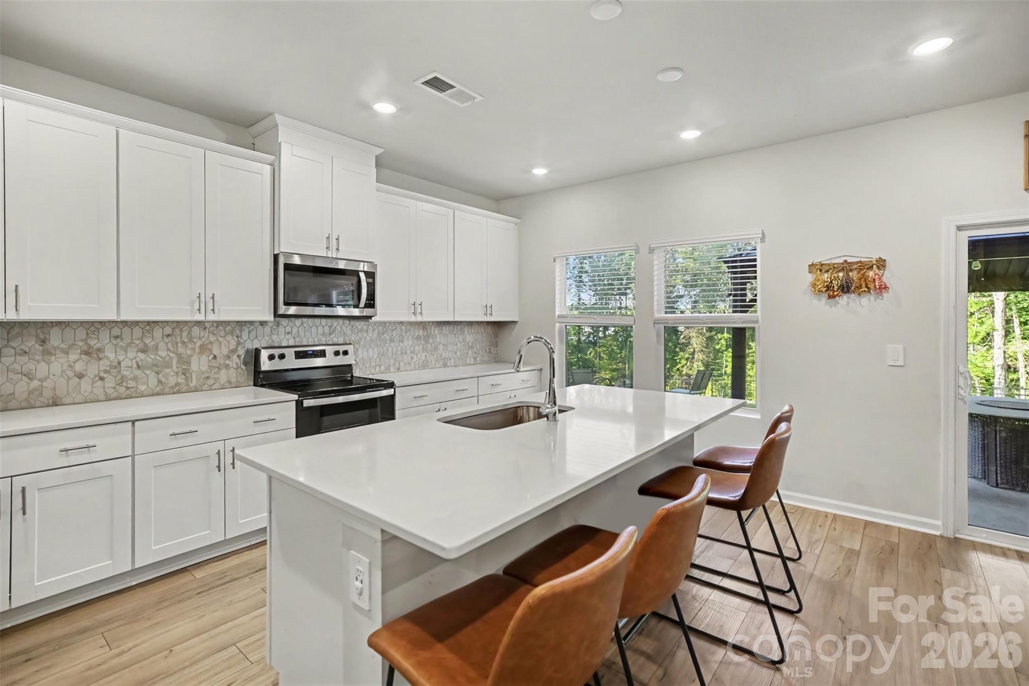 The kitchen island offers extra seating and prep space. - 1623 Baymont Court, Stanley