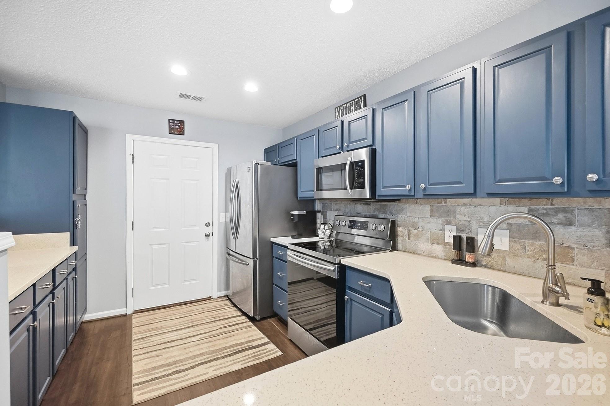 Kitchen with Quartz Countertops and Tiled Backsplash - 1719 Hidden Creek Drive, Rock Hill