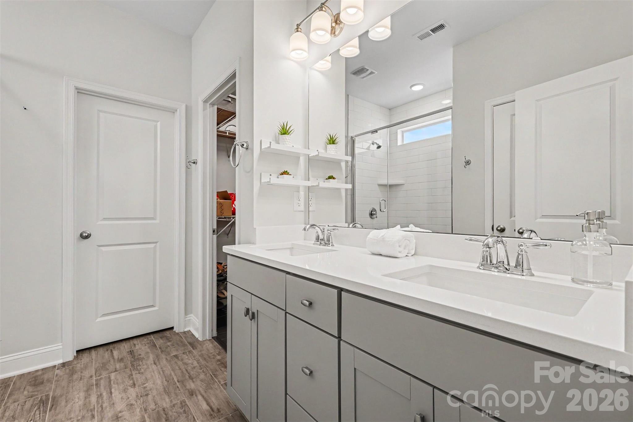 Primary bathroom with double vanity, large shower and water closet. - 6247 Six String Court, Fort Mill