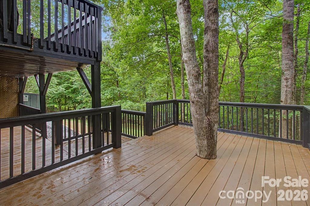 Tiered decks offer multiple options for outdoor living, creating versatile spaces to relax, entertain, and enjoy the surrounding views. - 30 Whippoorwill Drive, Weaverville