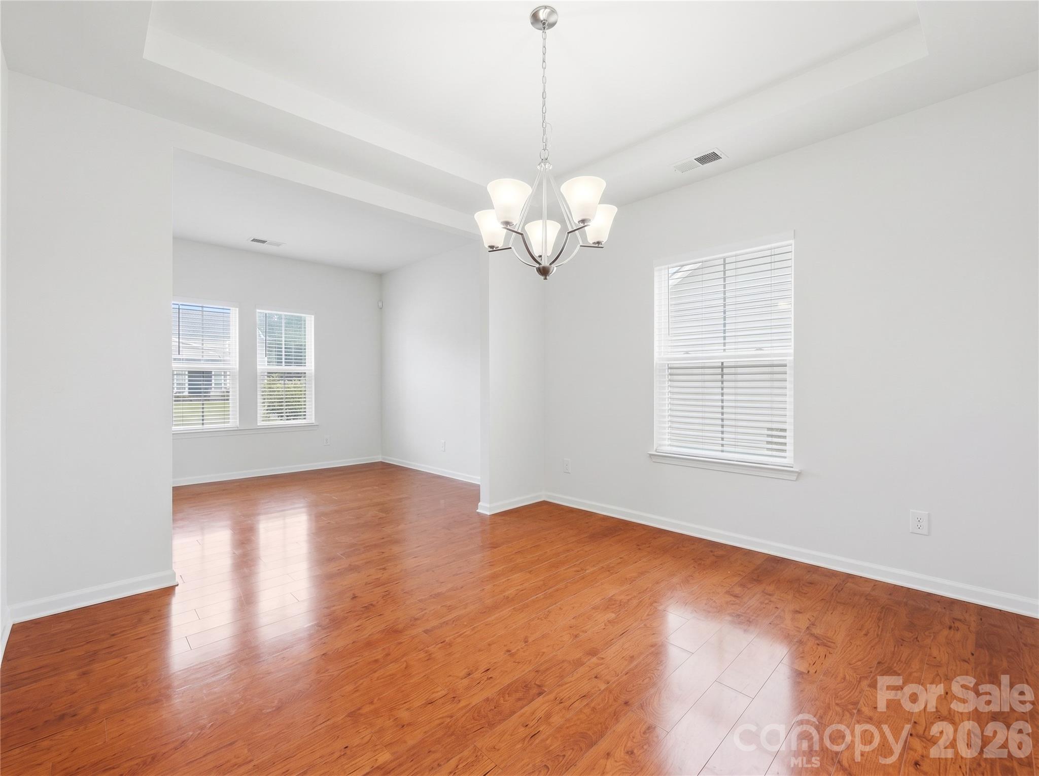 Dining Room: Formal dining room featuring hardwood flooring and plenty of space for gatherings. - 3341 Linetender Drive, Davidson