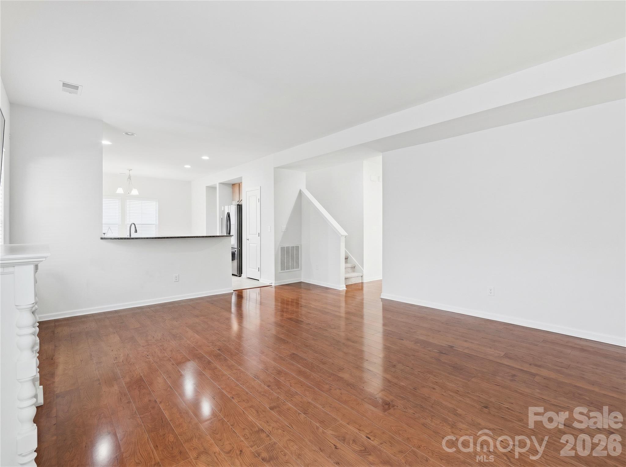 Living Room: Additional view showcasing the generous size and flexible furniture arrangement options, including breakfast bar seating. - 3341 Linetender Drive, Davidson