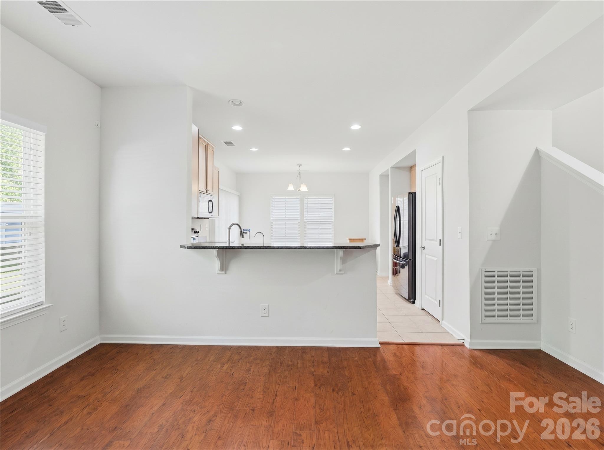 Living Room: Open-concept living area with easy flow to the kitchen and breakfast bar. - 3341 Linetender Drive, Davidson