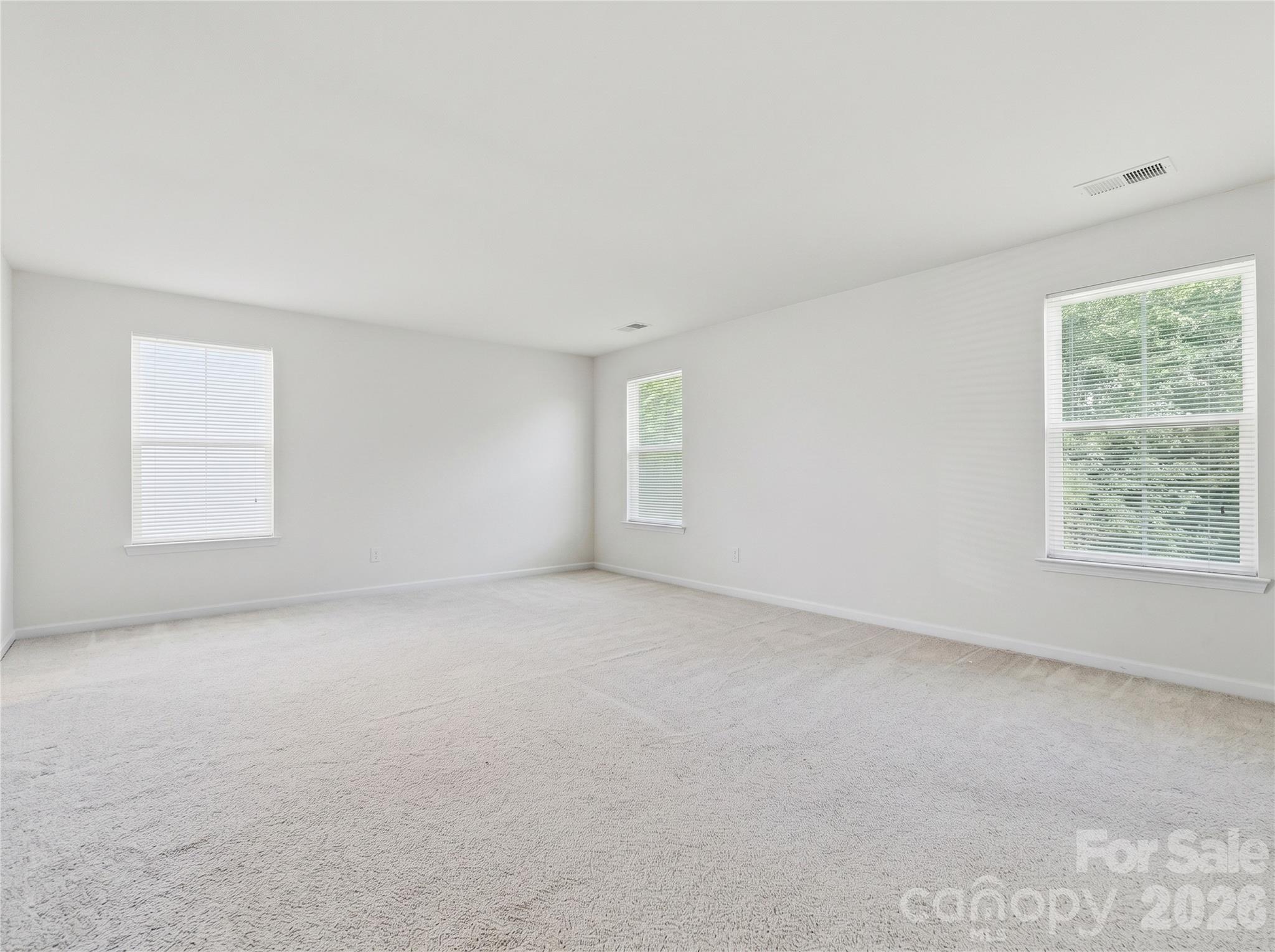 Primary Bedroom: Oversized primary suite with abundant natural light and room for a sitting area. - 3341 Linetender Drive, Davidson