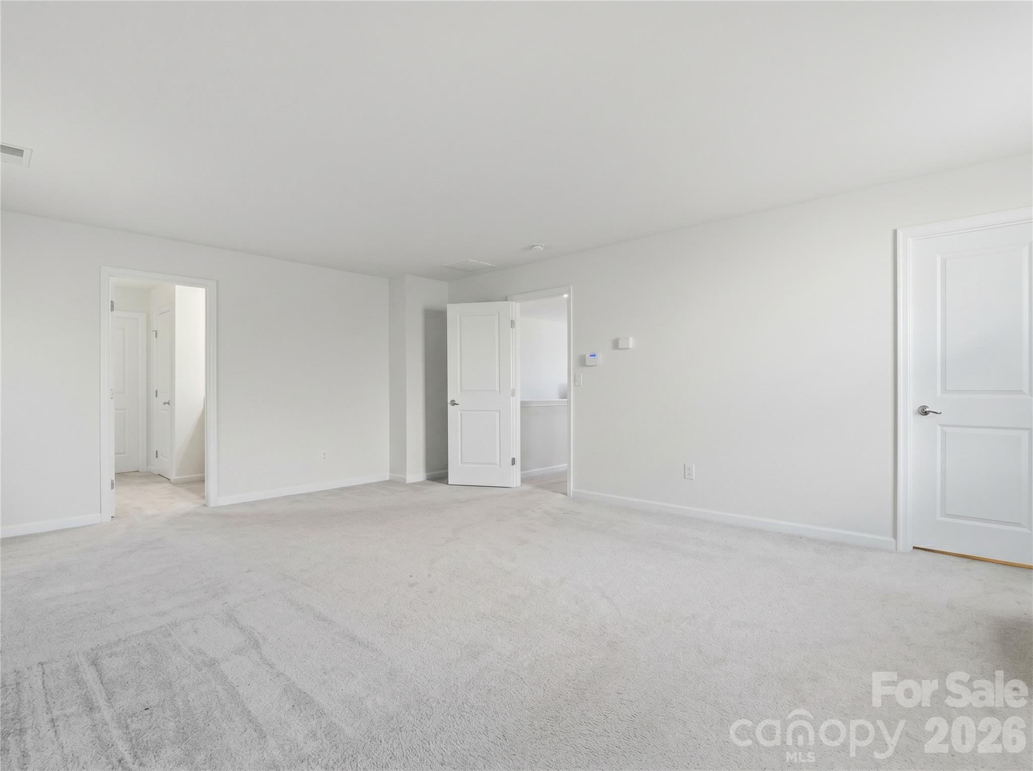 Primary Bedroom: Additional view showcasing the spacious layout and furniture flexibility. Large walk-in closet off the bedroom. - 3341 Linetender Drive, Davidson