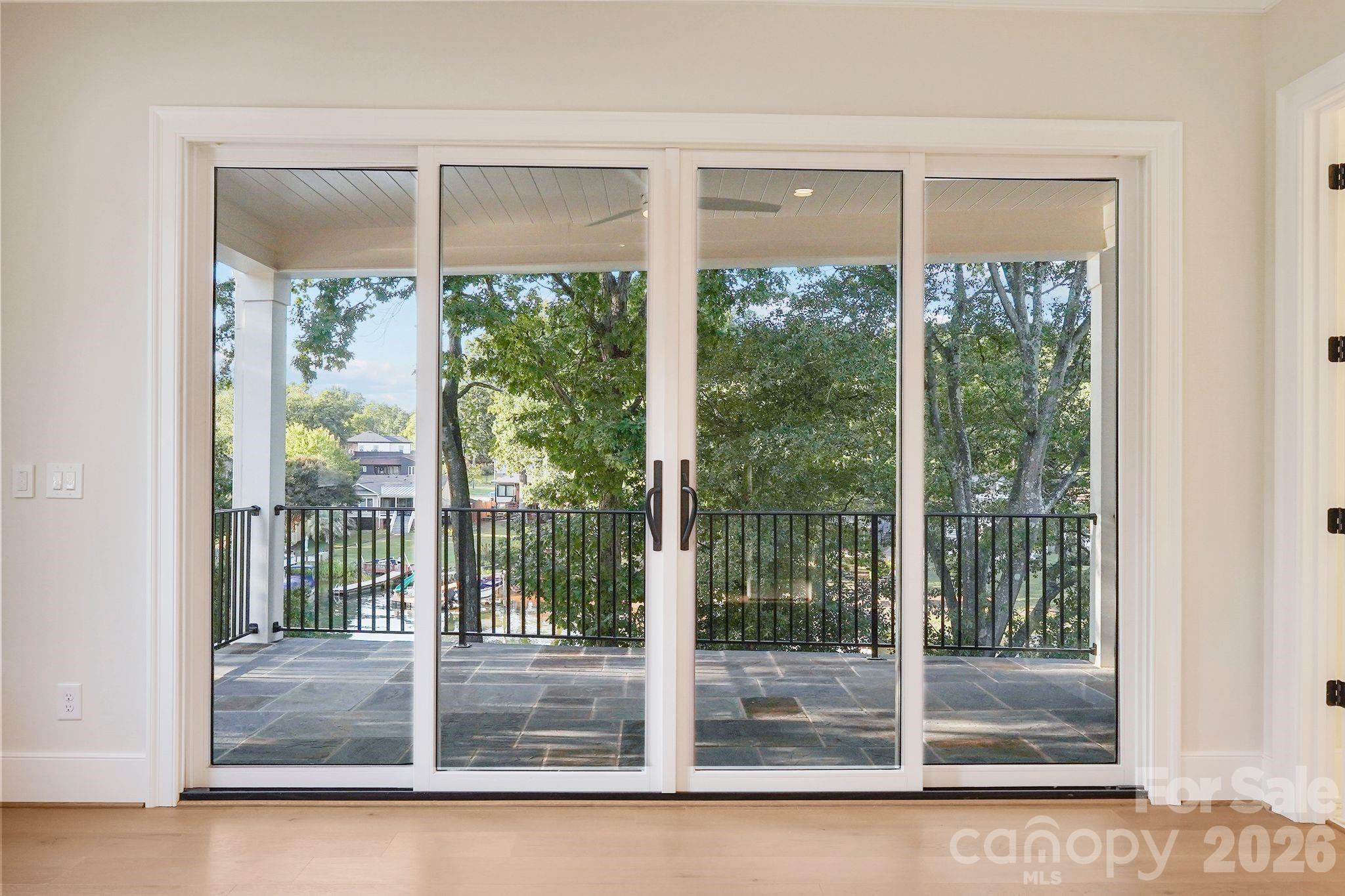 The primary suite opens to an exclusive private balcony overlooking the water, creating a serene retreat with beautiful lake views. - 21216 Rio Oro Drive, Cornelius