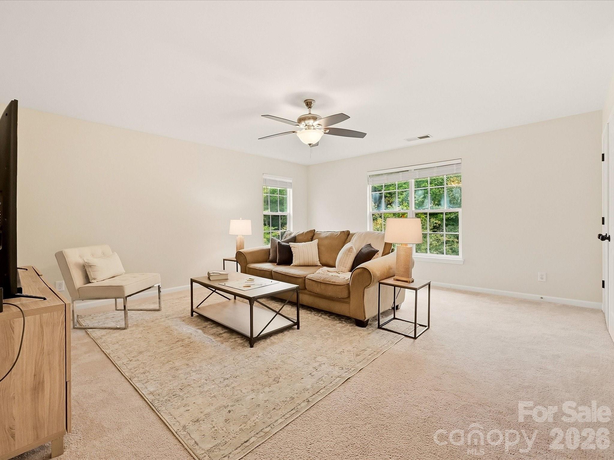 The spacious loft offers a bright, flexible second living area with abundant natural light and plenty of room for a media space, playroom, home office, or game room. - 16006 Lavenham Road, Huntersville
