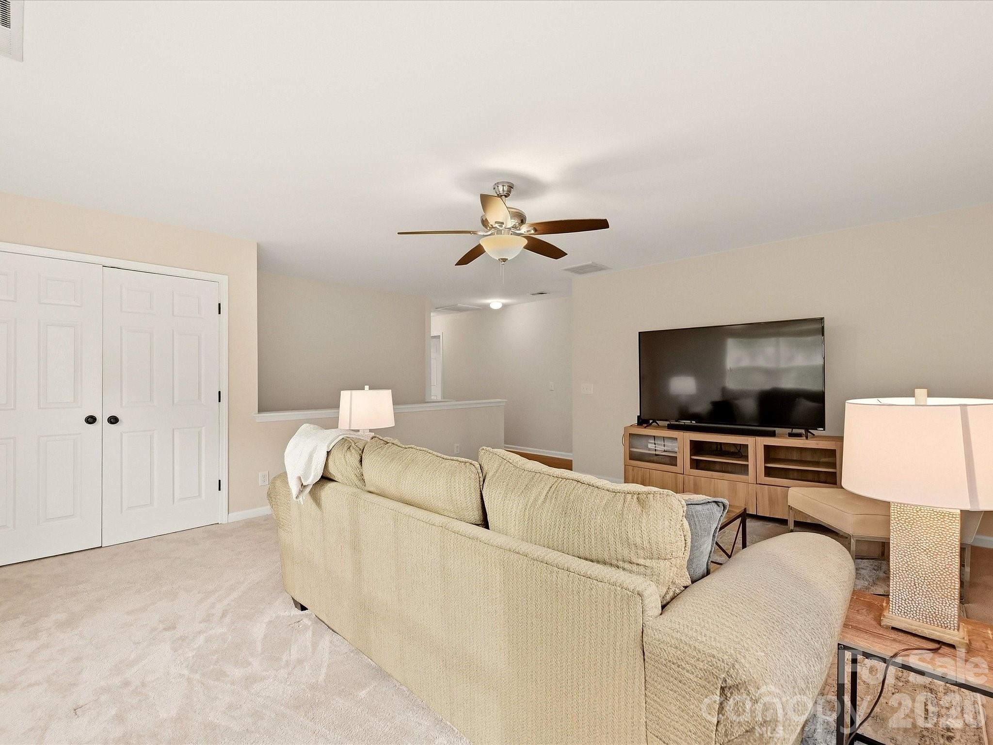 The spacious loft offers a bright, flexible second living area with abundant natural light and plenty of room for a media space, playroom, home office, or game room. - 16006 Lavenham Road, Huntersville