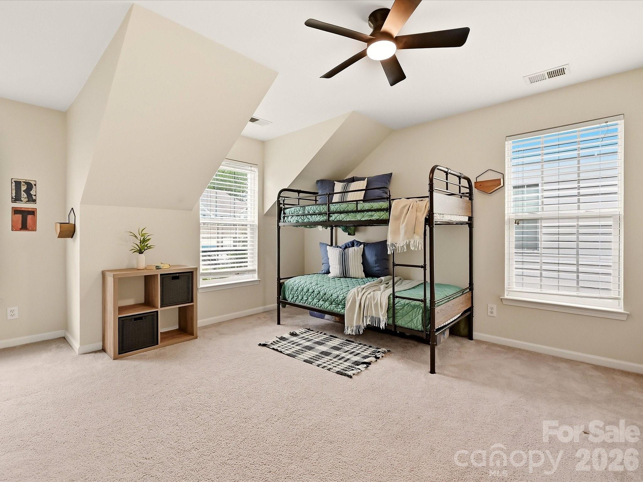 Flex Room currently used as a bedroom offers a spacious, flexible layout with abundant natural light, unique architectural details, and room for sleeping, studying, or play. - 16006 Lavenham Road, Huntersville