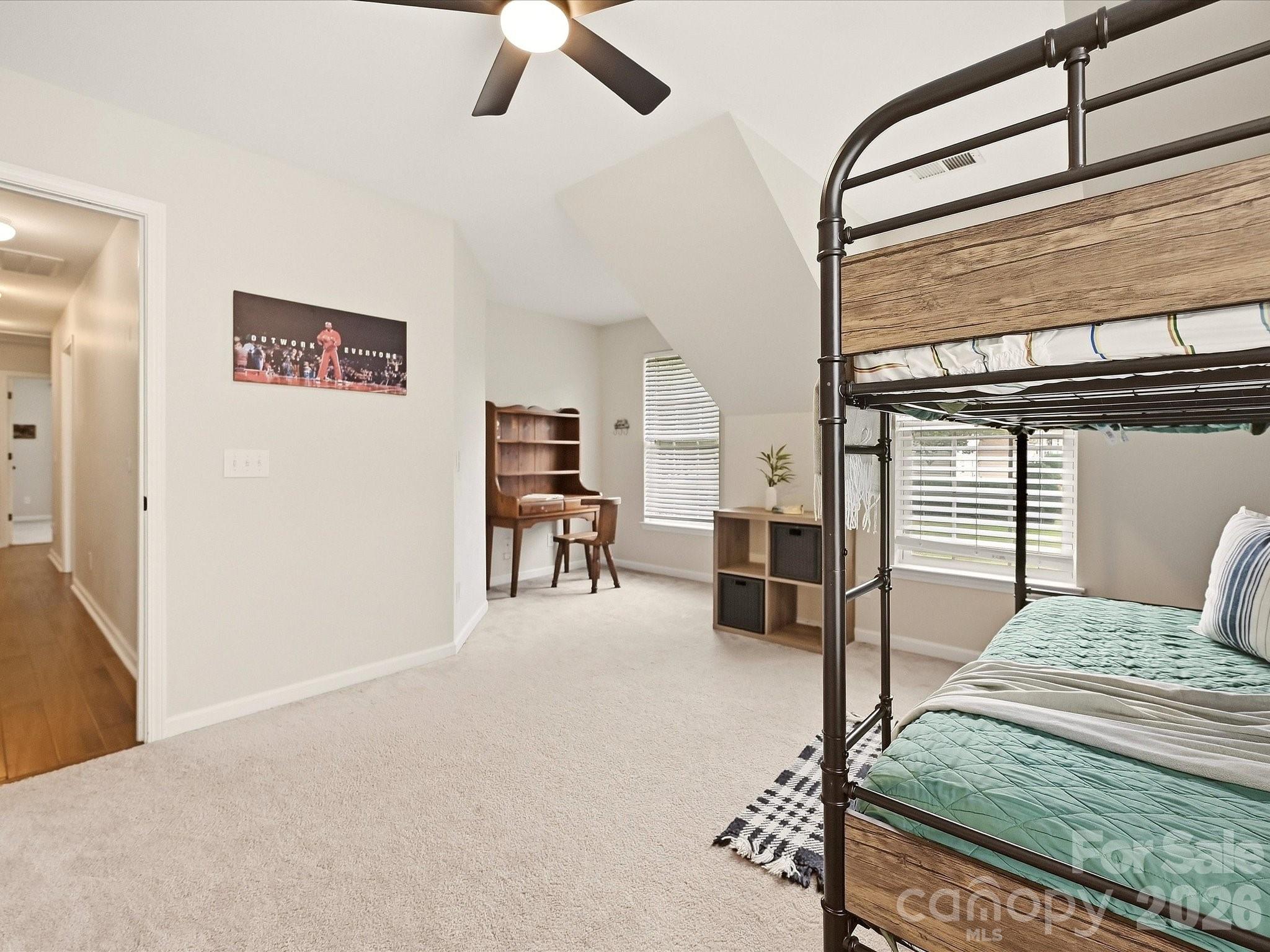 Flex room currently used as a bedroom offers a spacious, flexible layout with abundant natural light, unique architectural details, and room for sleeping, studying, or play. - 16006 Lavenham Road, Huntersville