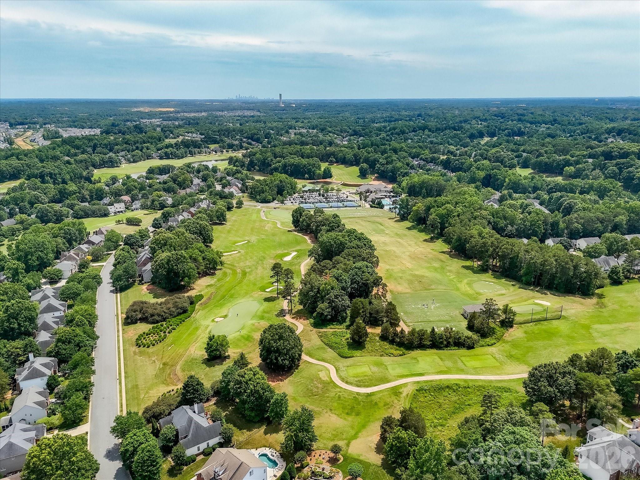 Aerial views of NorthStone showcase the community’s impressive amenities, including the golf course, clubhouse, swimming pools, tennis courts, and beautifully maintained grounds. - 16006 Lavenham Road, Huntersville