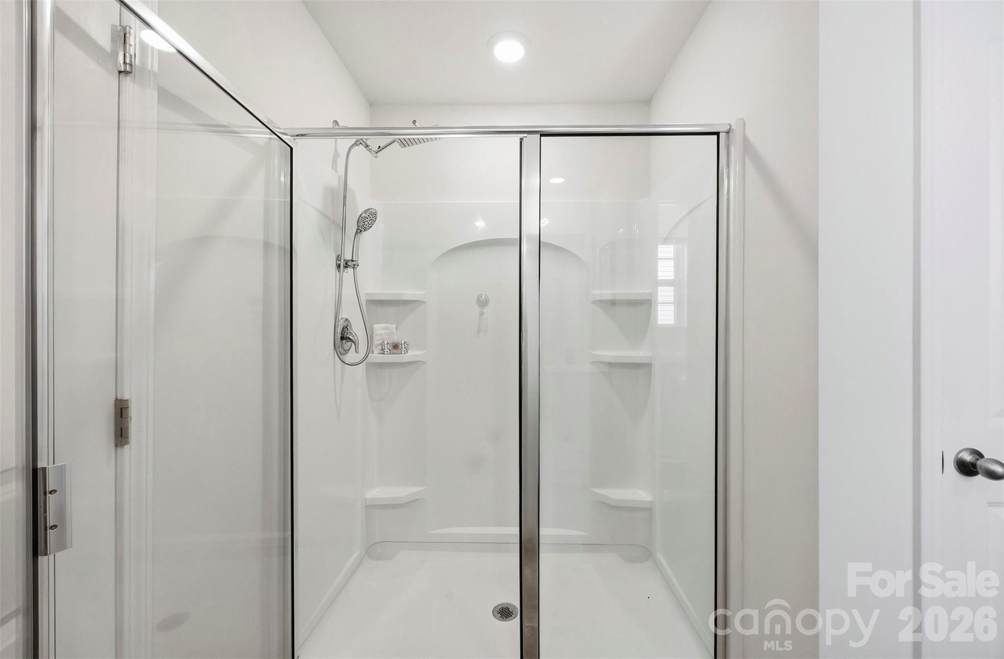 Upper level primary suite ensuite bathroom-walk in shower - 7572 Nolen Farm Drive, Gastonia