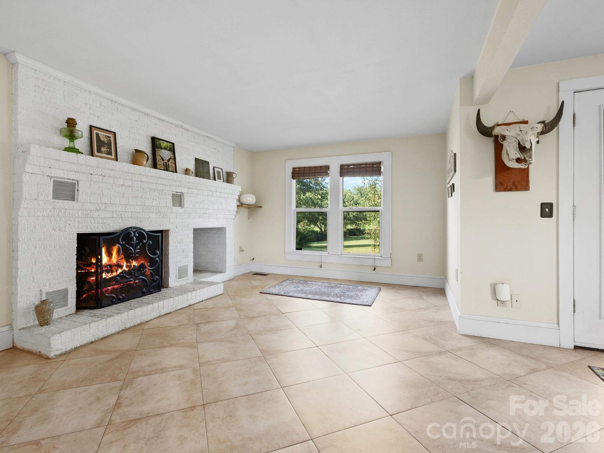 The heart of the home is a Great Room with doors leading out to the deck, a center cooking island, and a fireplace. - 157 J A Hampton Road, Rutherfordton