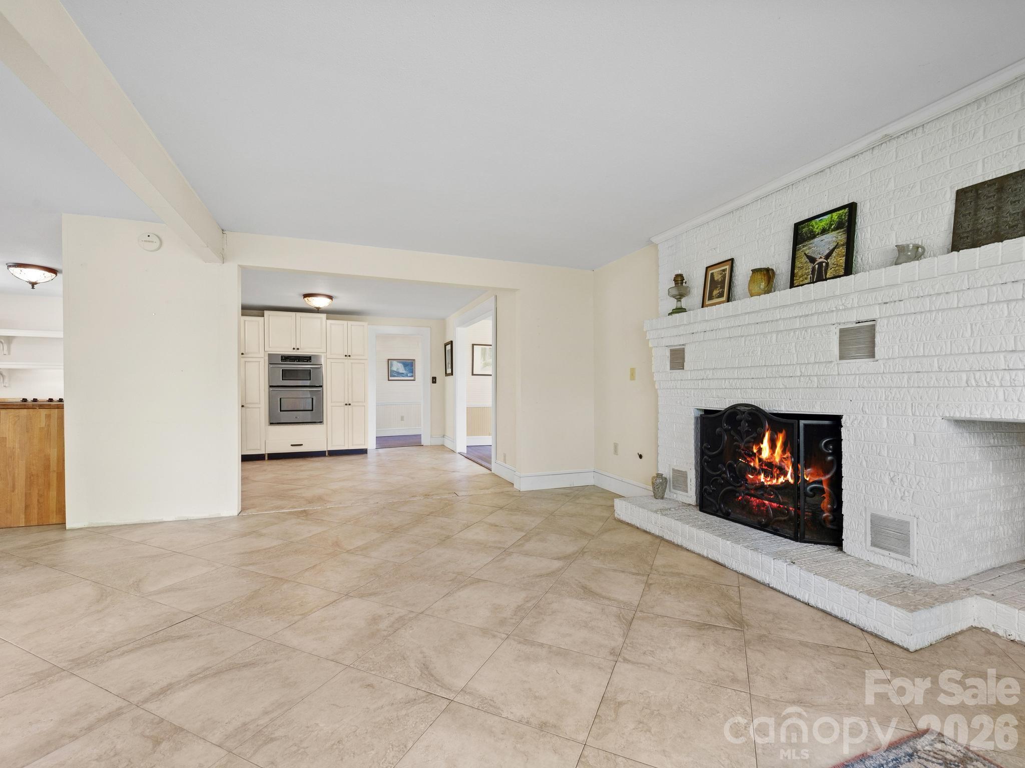 The heart of the home is a Great Room with doors leading out to the deck, a center cooking island, and a fireplace. - 157 J A Hampton Road, Rutherfordton