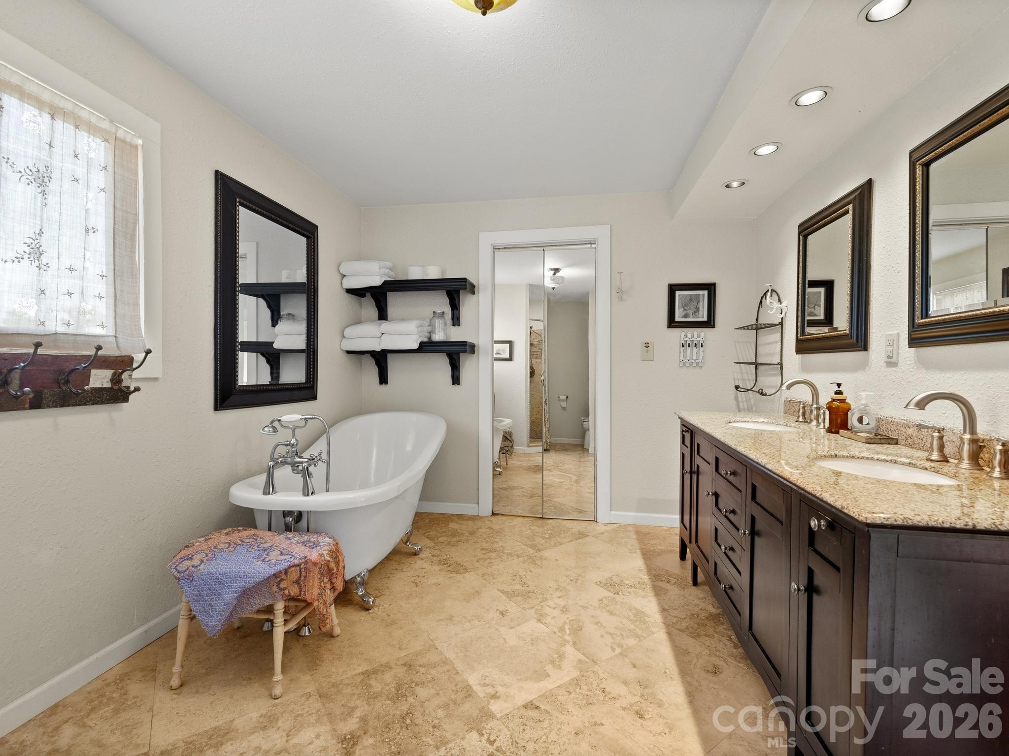 Primary ensuite bathroom features a freestanding tub and a separate shower; double sink and walk-in closet - 157 J A Hampton Road, Rutherfordton