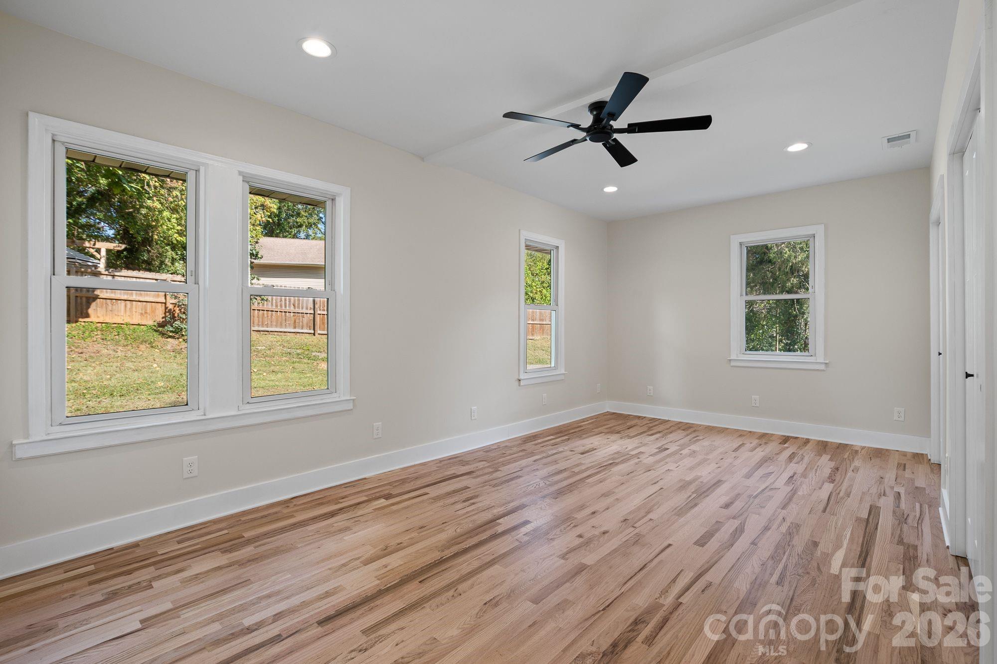Primary Bedroom: Spacious main-level primary suite with private en-suite bath. - 156 State Street, Asheville