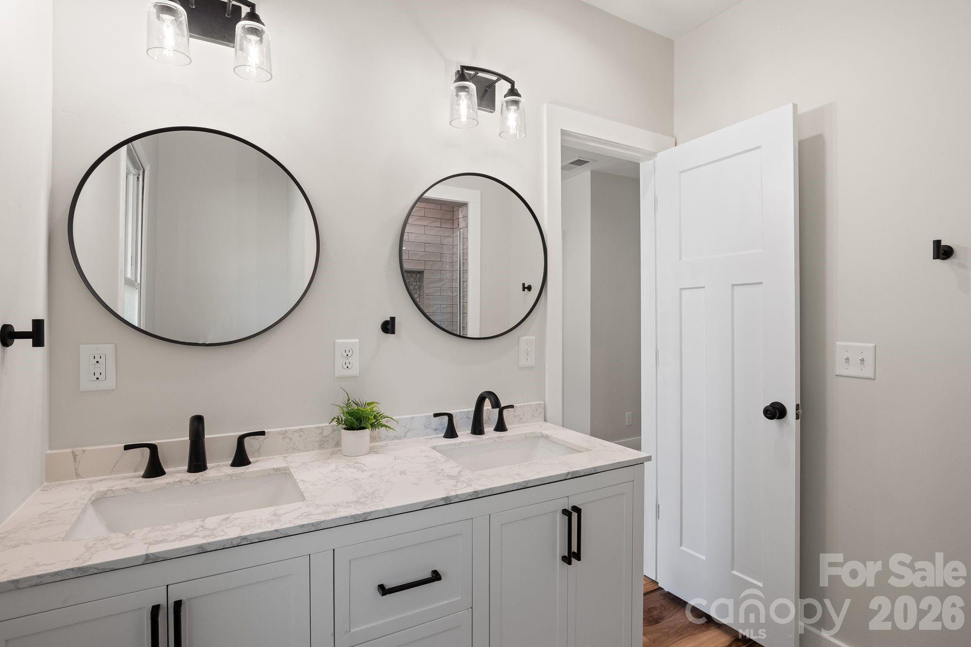 Primary En-Suite: Updated bathroom with dual vanity and modern finishes. - 156 State Street, Asheville